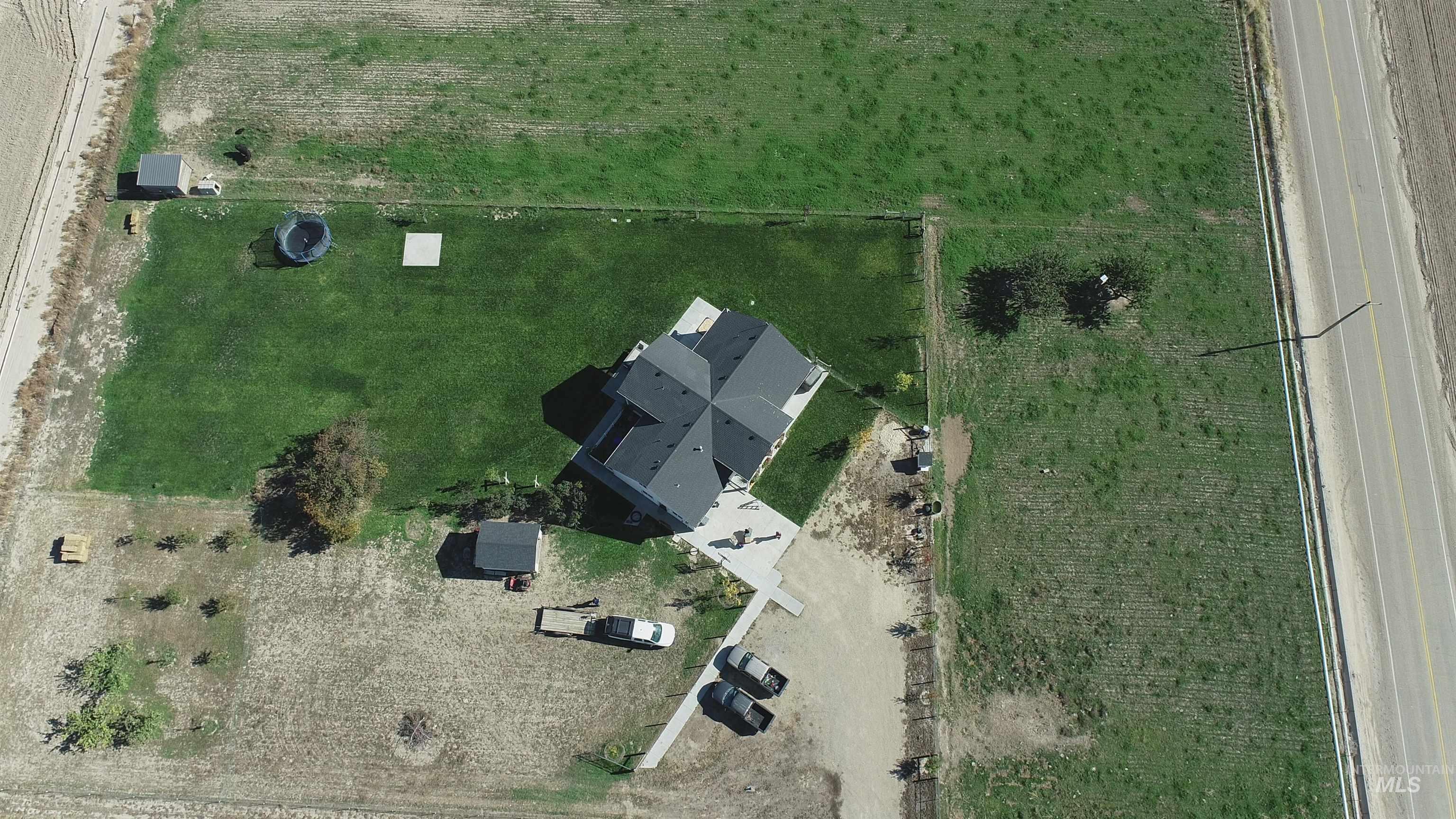 Aerial view of property and surrounding area featuring rural landscape