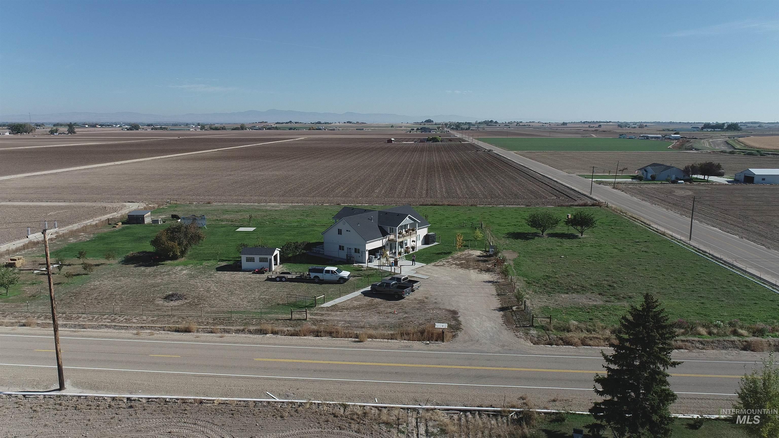 Aerial view of sparsely populated area featuring rows of crops