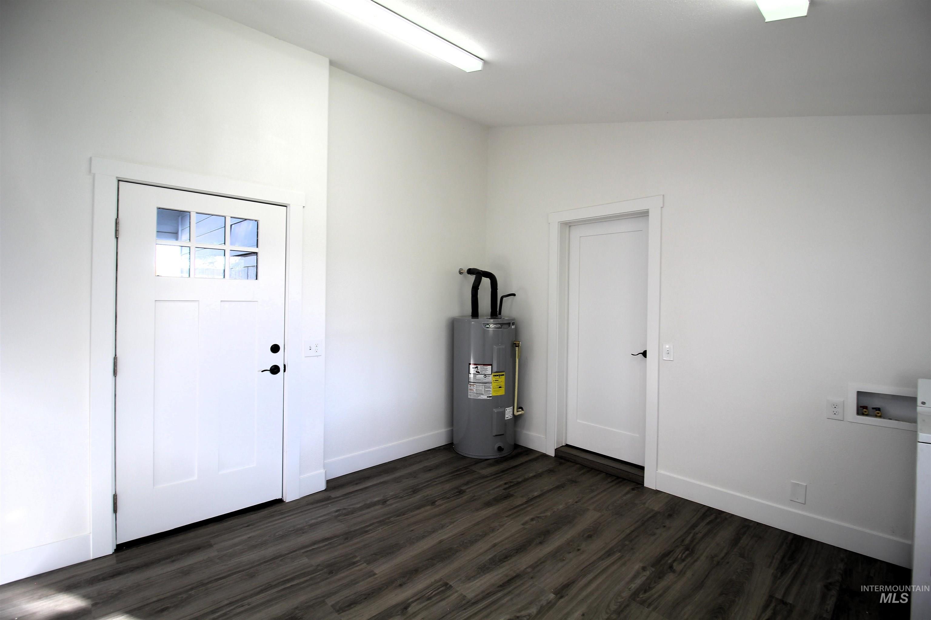 Utility room featuring electric water heater