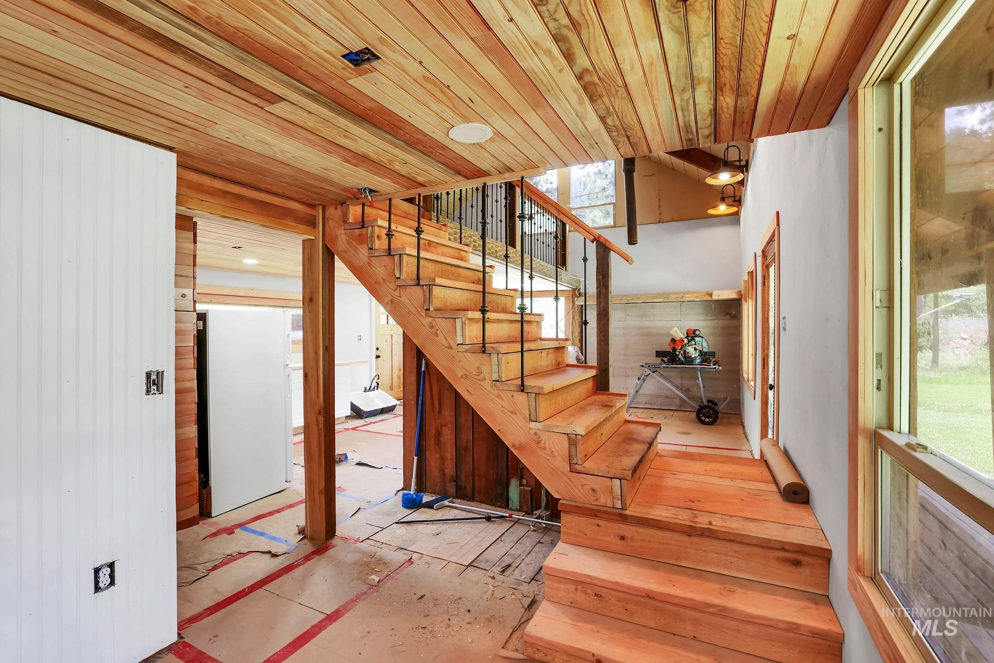 Stairway featuring wood ceiling