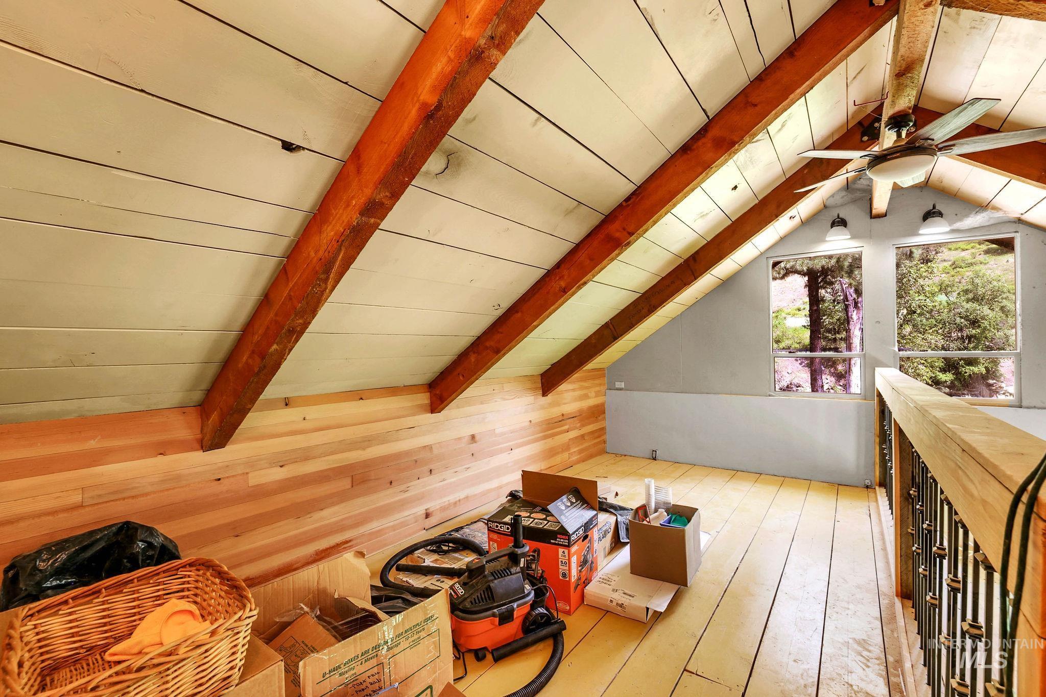 Interior space featuring hardwood / wood-style floors, ceiling fan, wood walls, and wooden ceiling