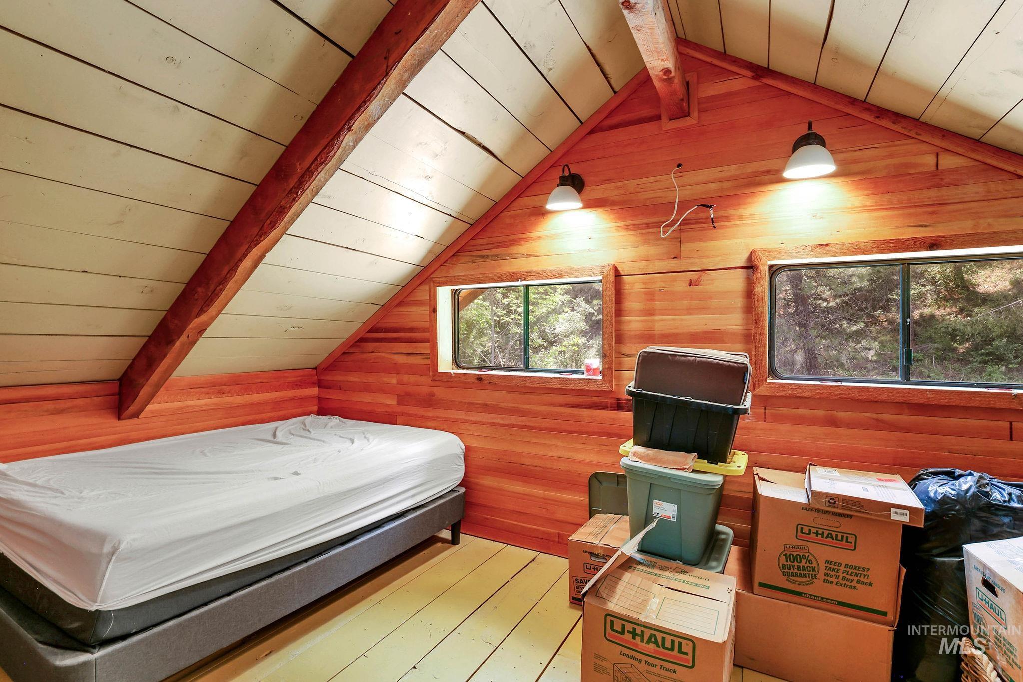 Bedroom featuring wood ceiling, wood walls, and wood finished floors