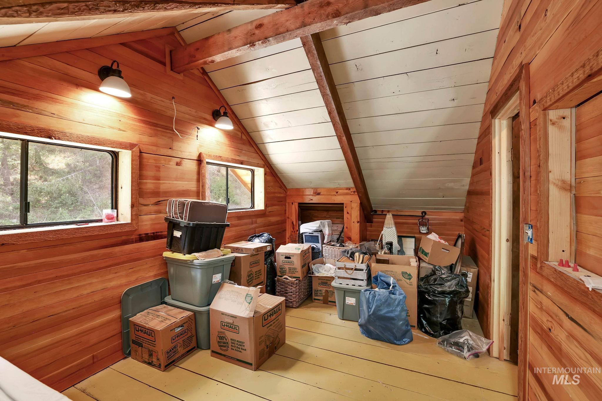 bedroom featuring wood walls