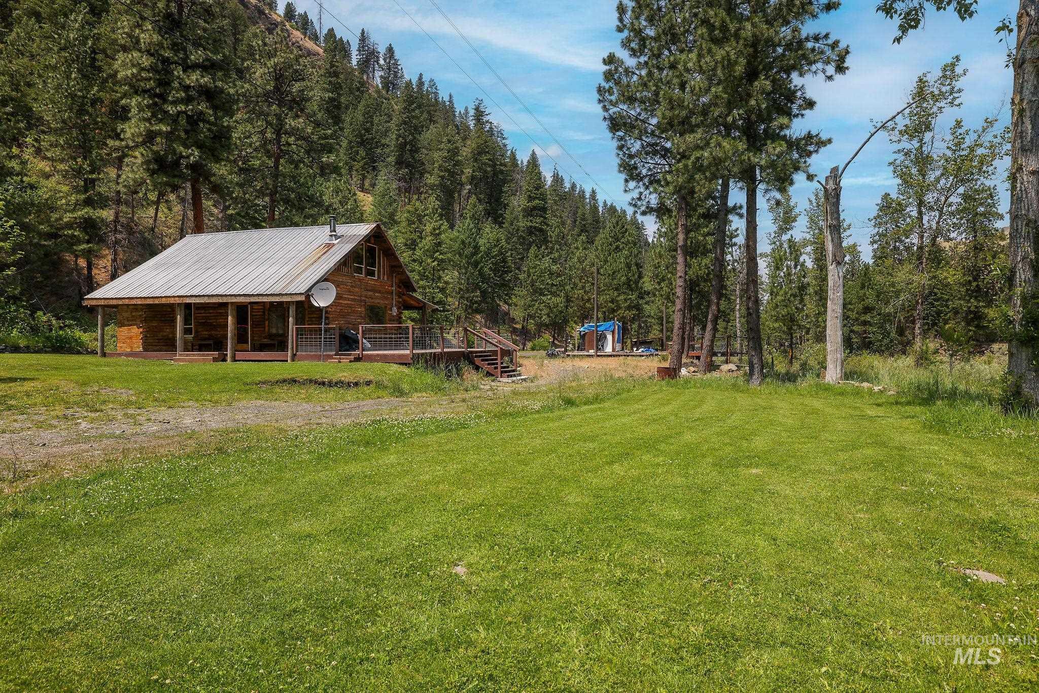 View of grassy yard featuring a view of trees