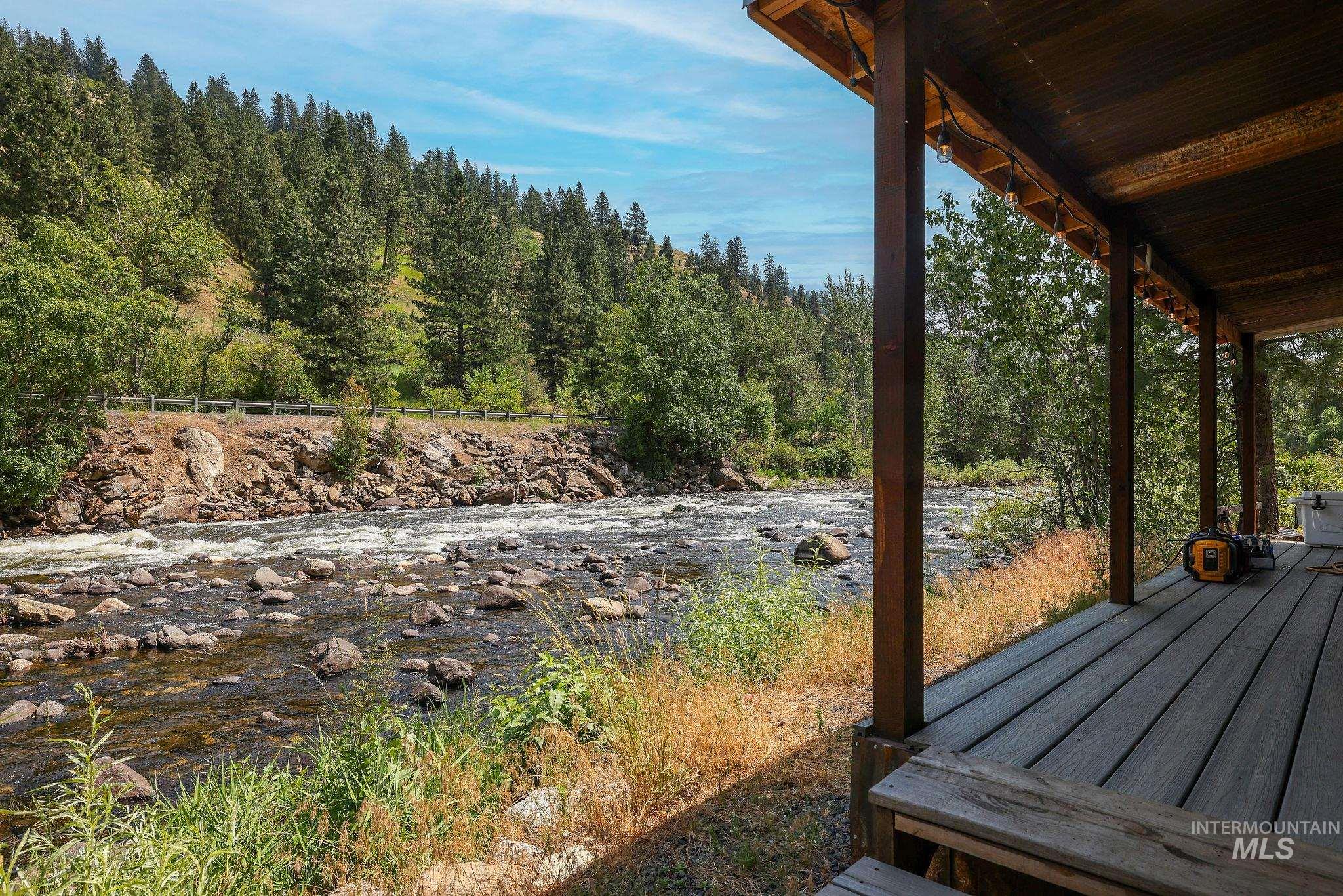 Wooden terrace featuring a forest view