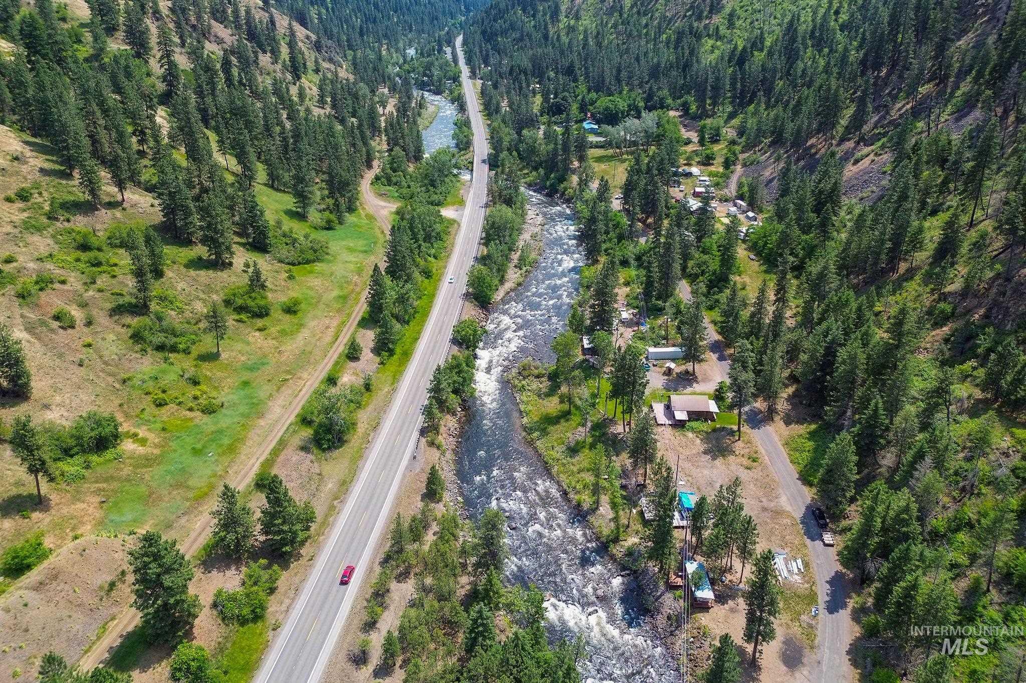View of property location with a heavily wooded area