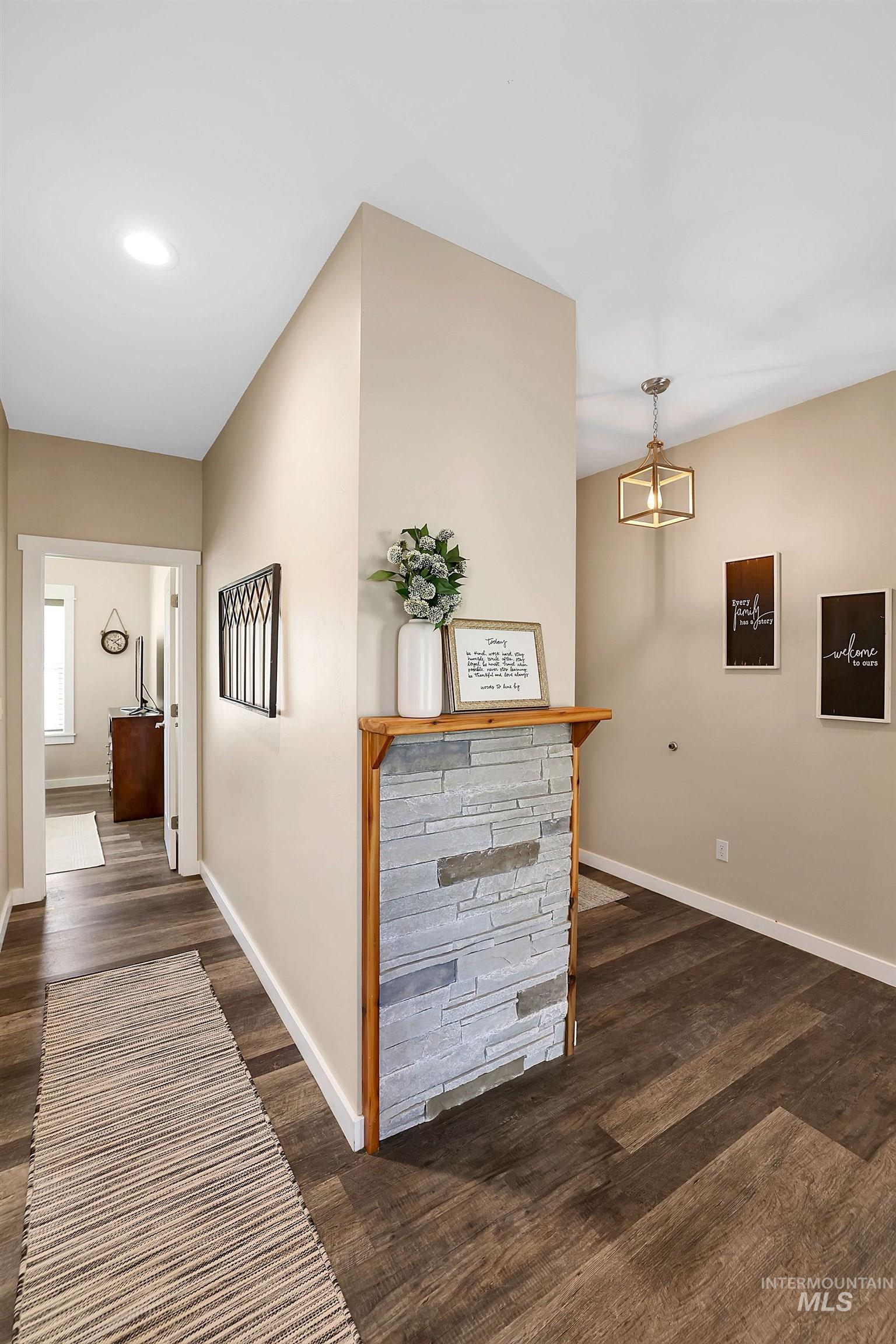 Hall with dark wood-type flooring, a chandelier, and recessed lighting