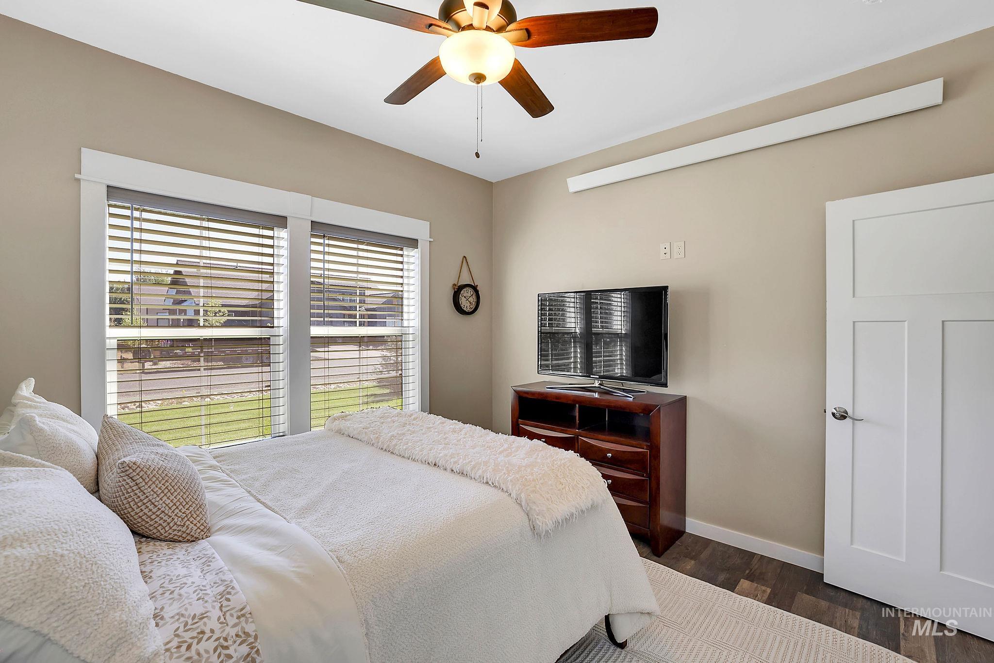 Bedroom with wood finished floors and a ceiling fan