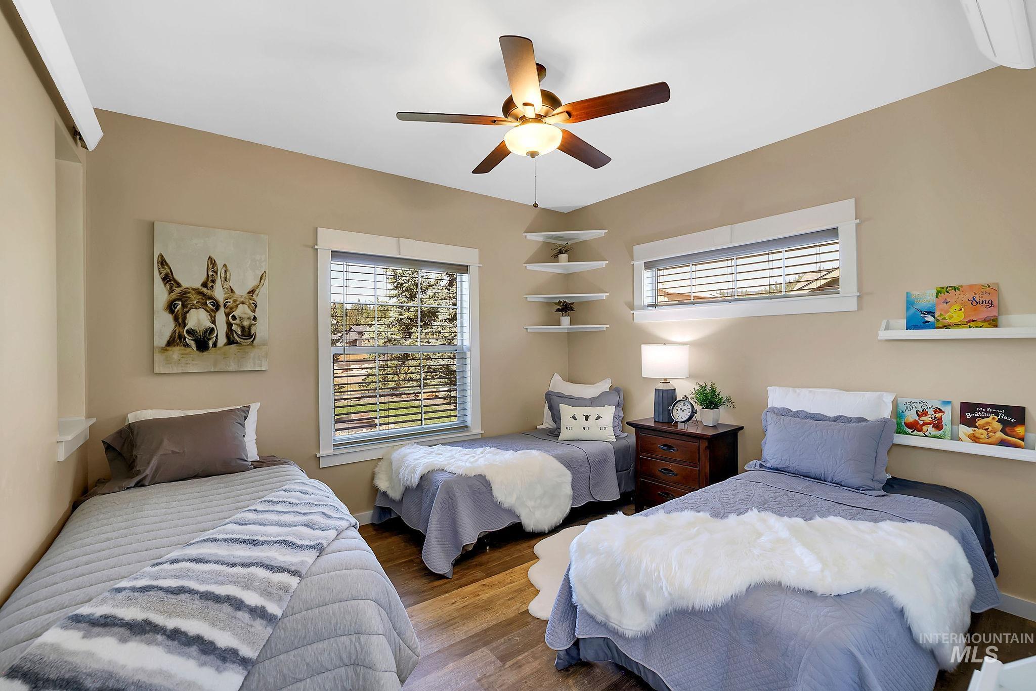 Bedroom featuring wood finished floors and ceiling fan