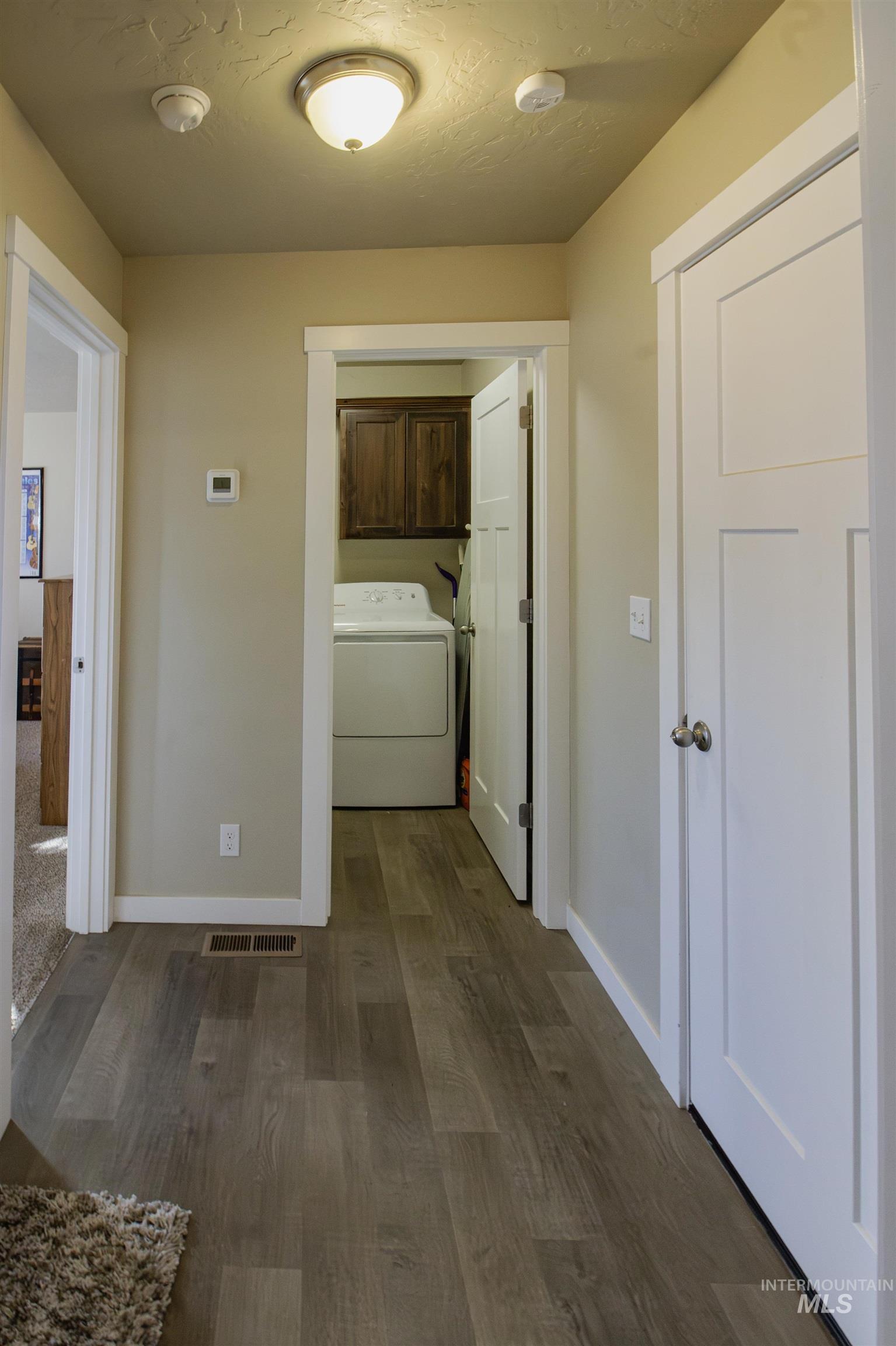 Hallway to master bedroom, laundry room and the garage