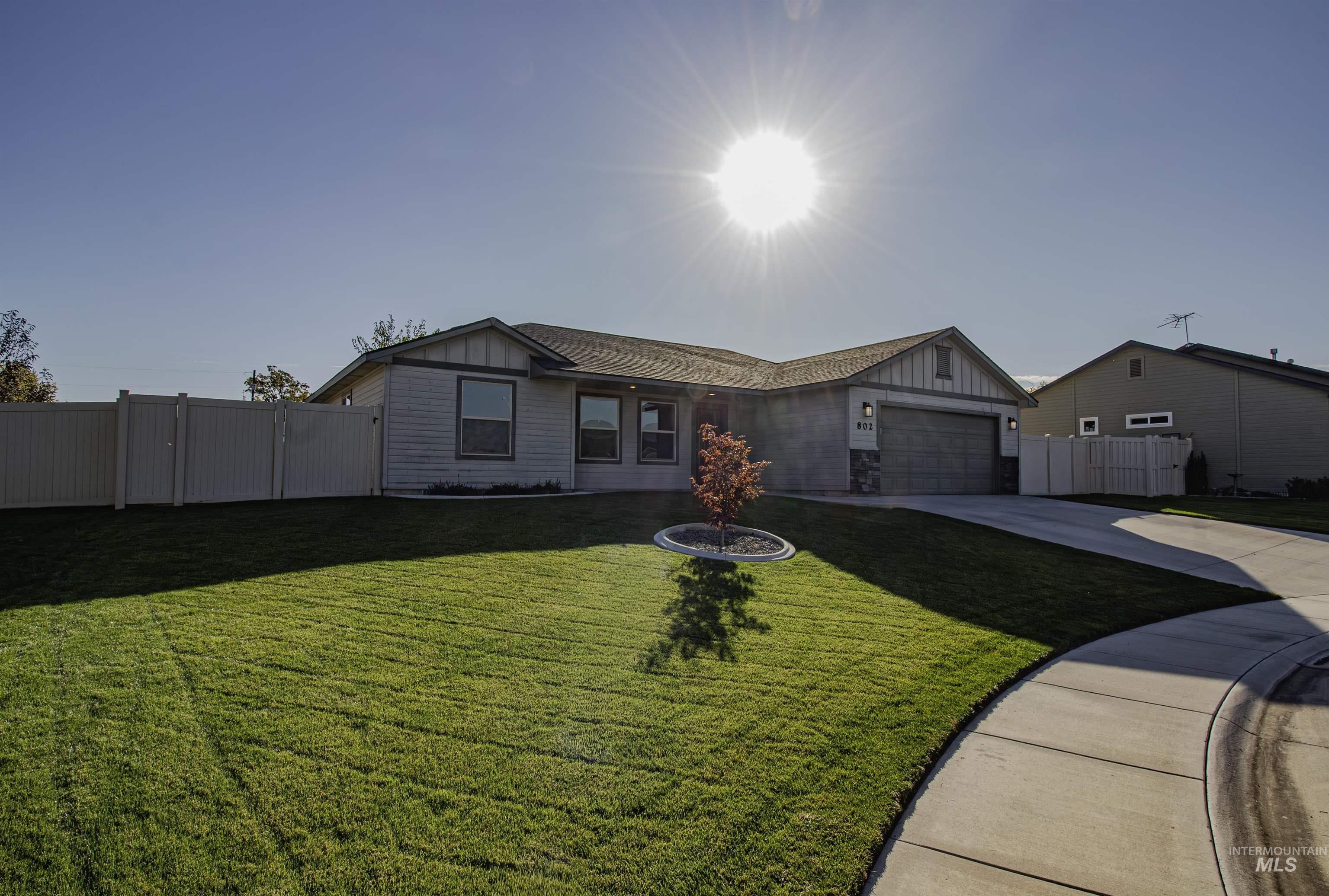 Single story home featuring board and batten siding, concrete driveway, and an attached garage
