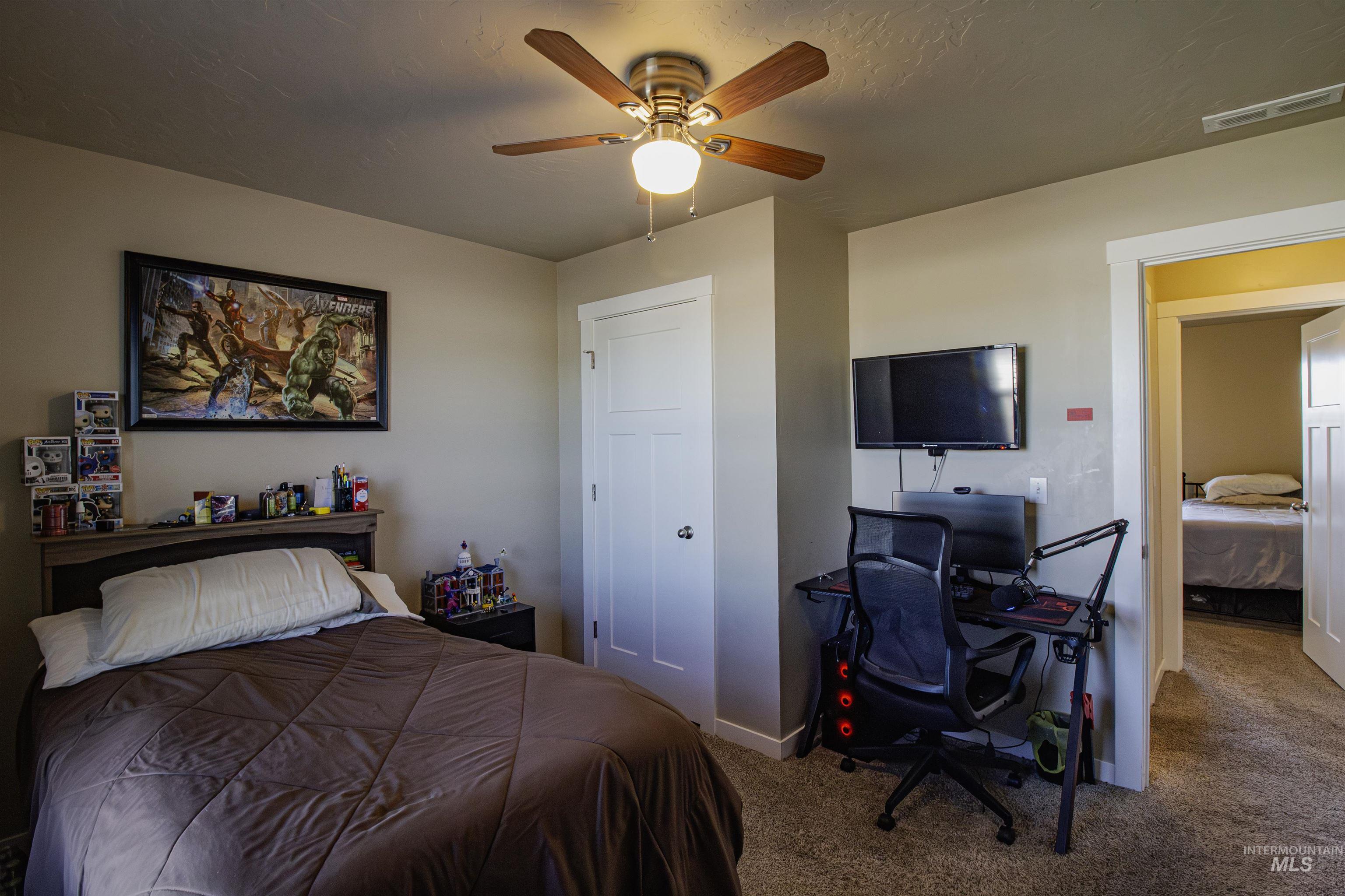Bedroom with carpet floors, and a ceiling fan