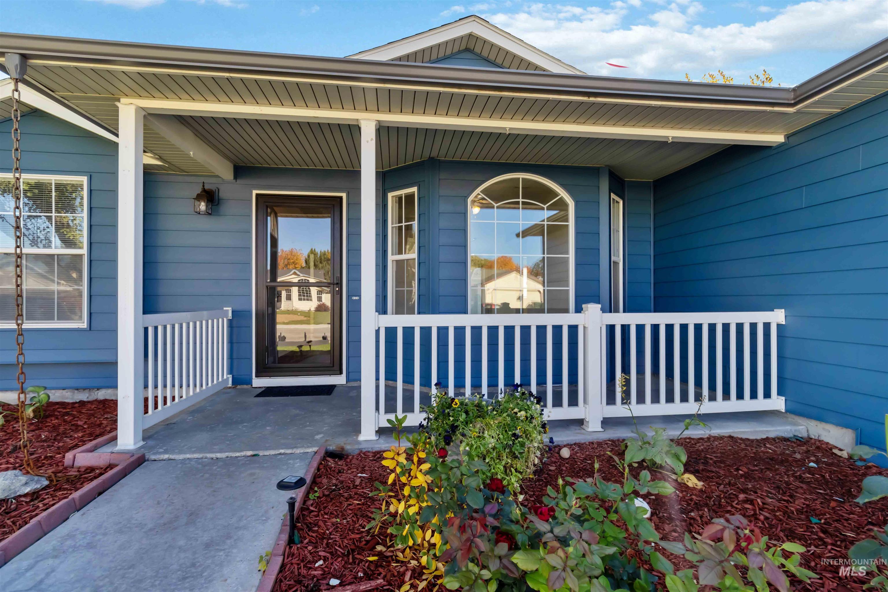 Doorway to property featuring covered porch