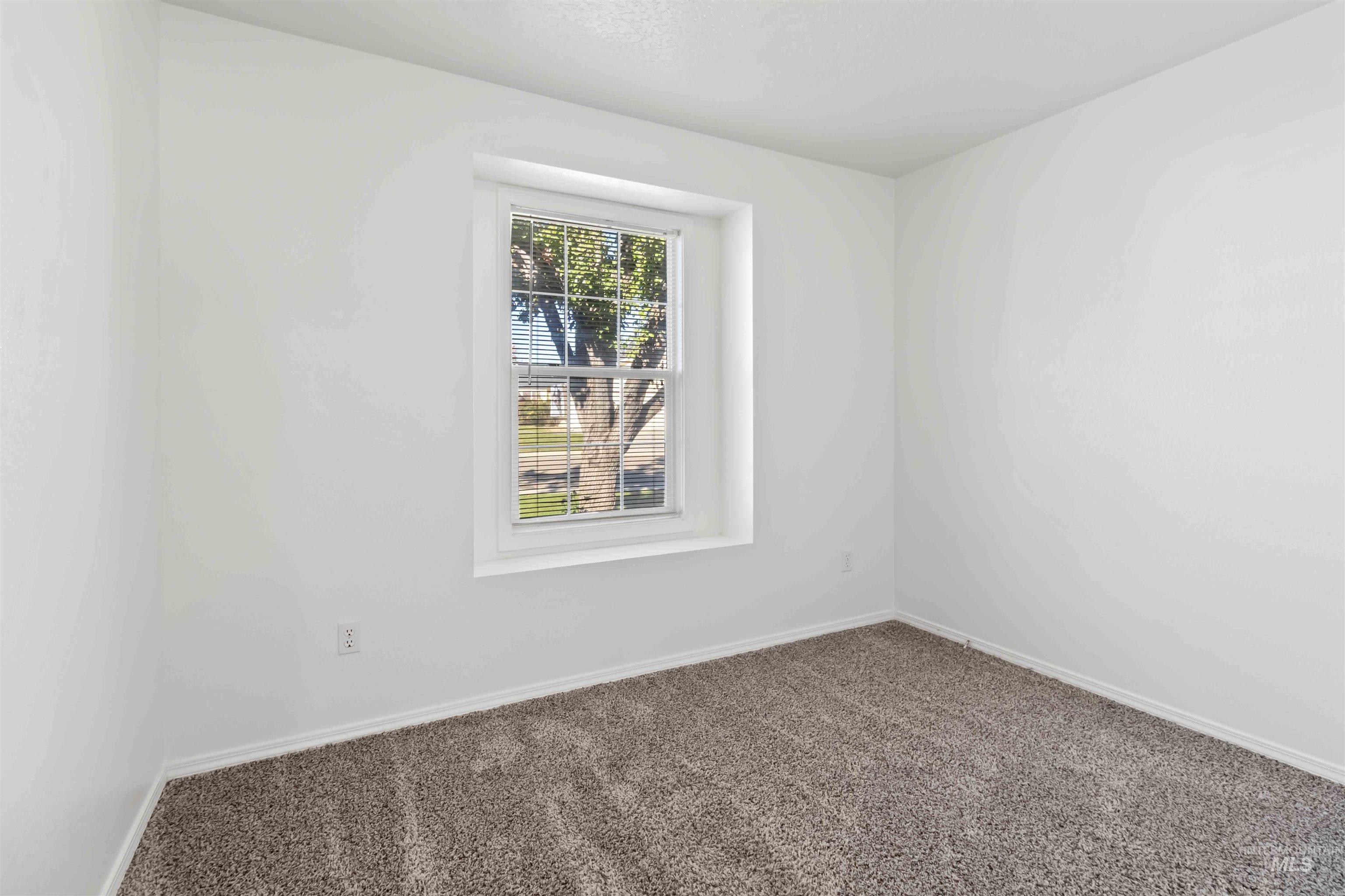 Unfurnished room featuring carpet floors and baseboards