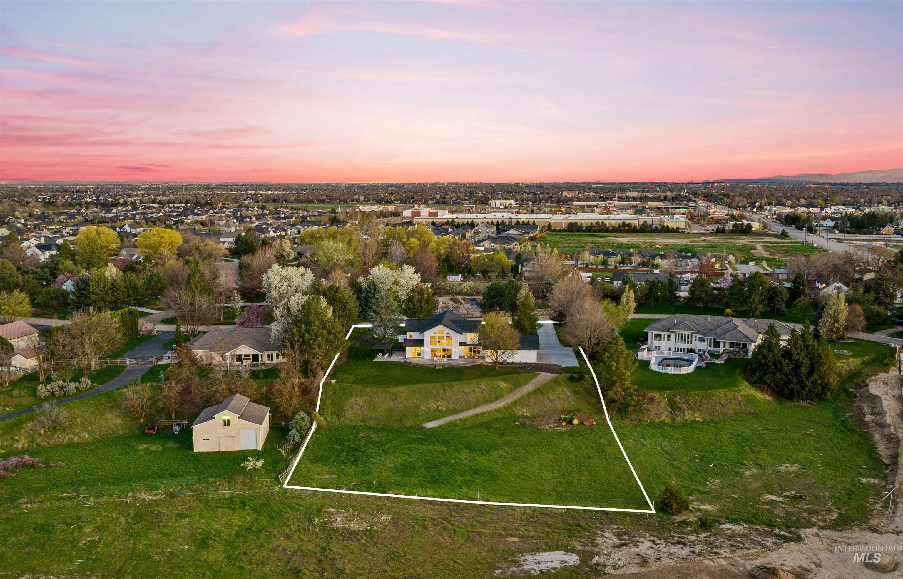 Aerial view at dusk of a residential view and property parcel outlined