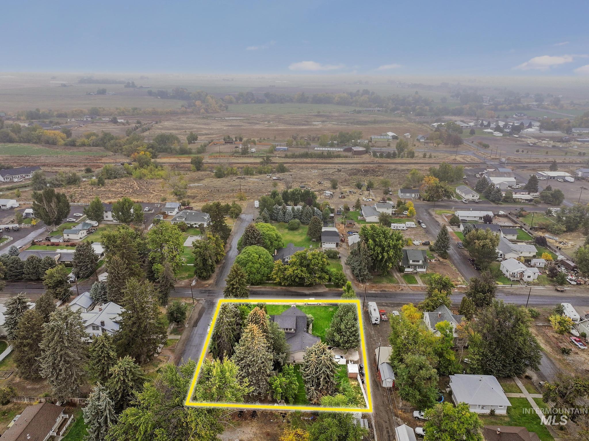 Aerial perspective of suburban area featuring property parcel outlined