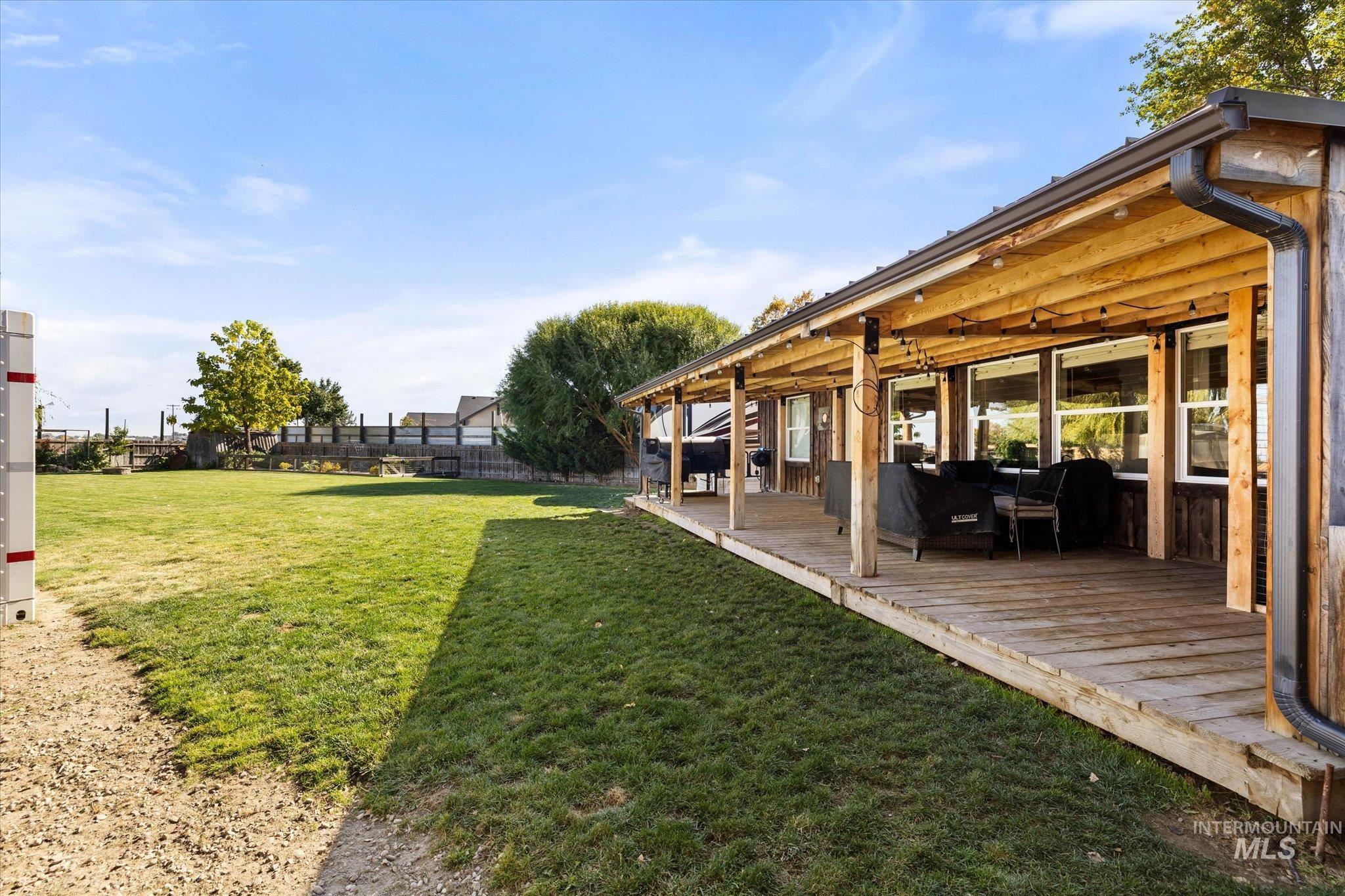 Fenced backyard with a wooden deck