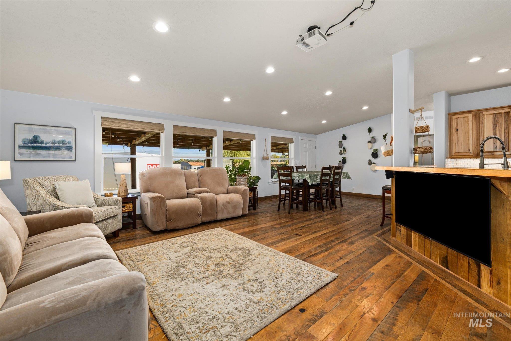 Living room featuring dark wood-style flooring and recessed lighting