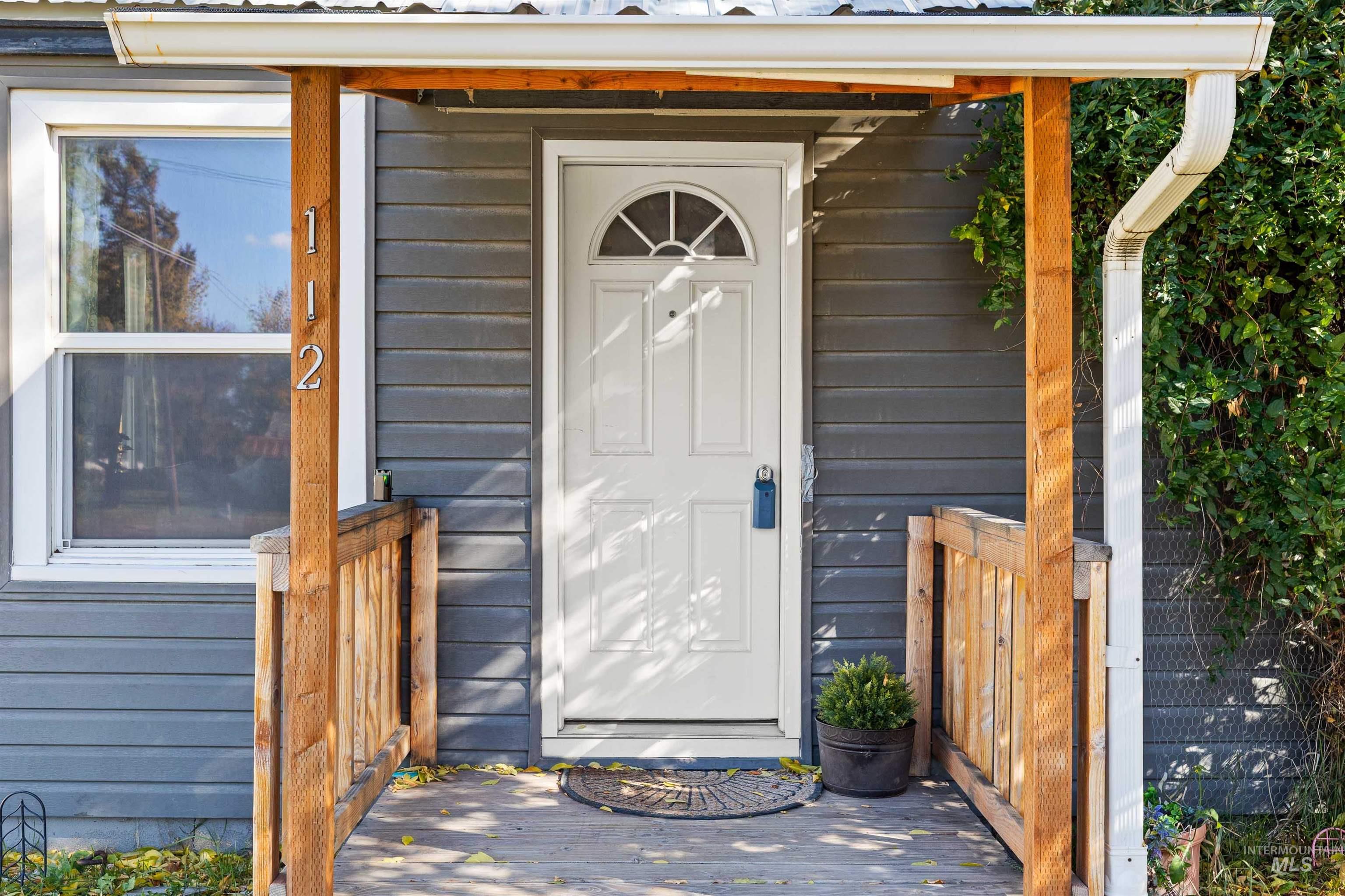 Property entrance featuring a metal roof
