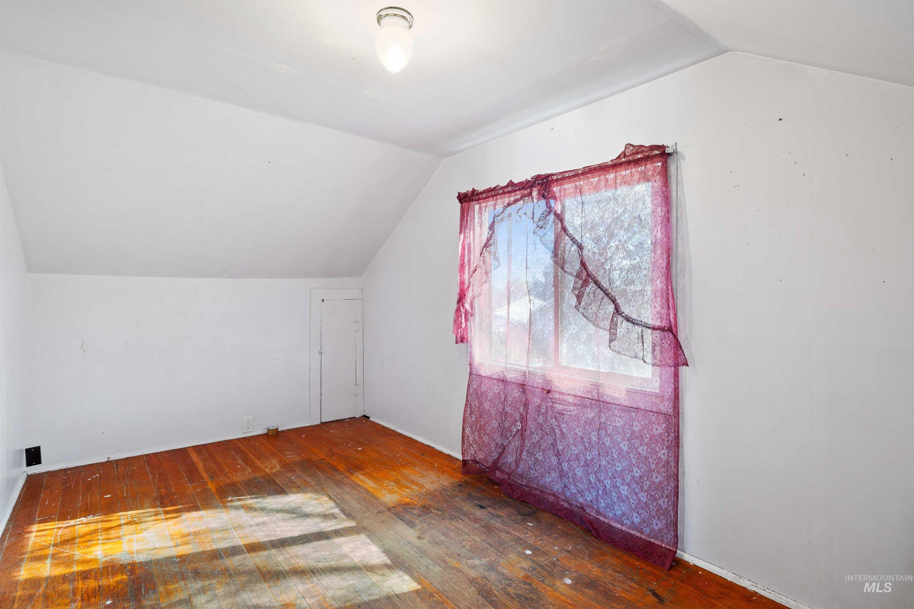 Bonus room featuring vaulted ceiling and hardwood / wood-style flooring