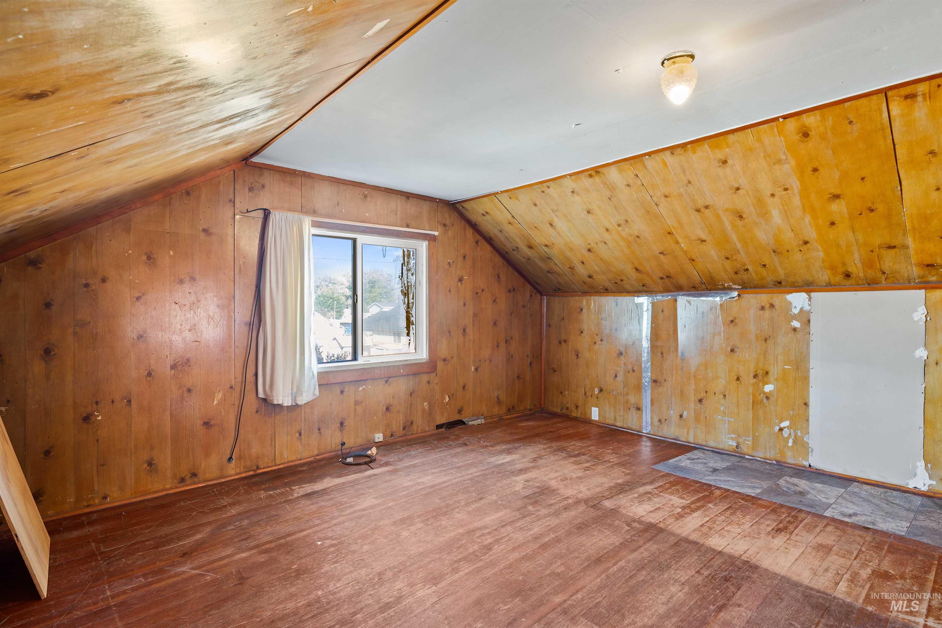 Bonus room with hardwood / wood-style floors, vaulted ceiling, wood walls, and wooden ceiling