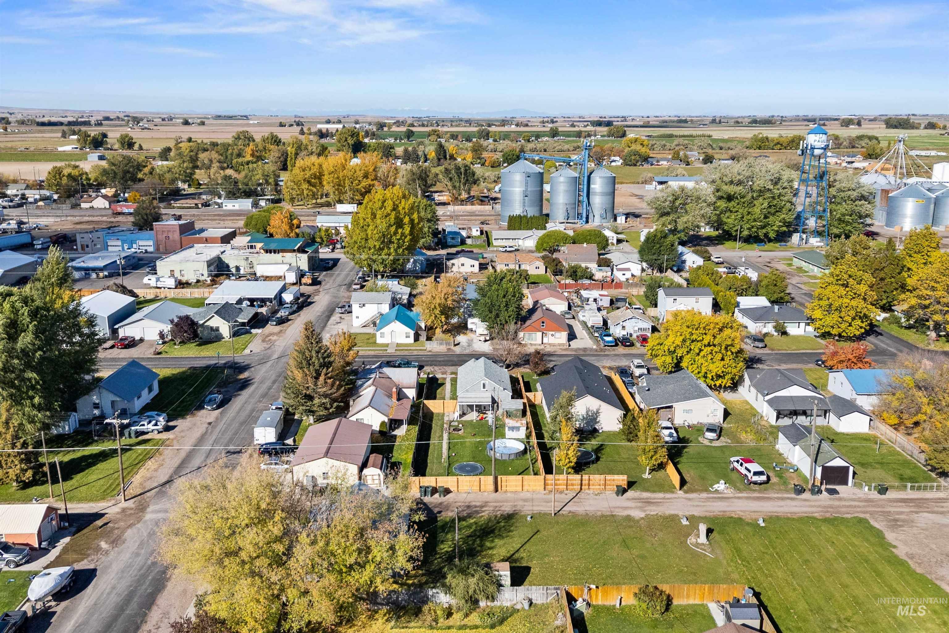Aerial view of property and surrounding area featuring nearby suburban area