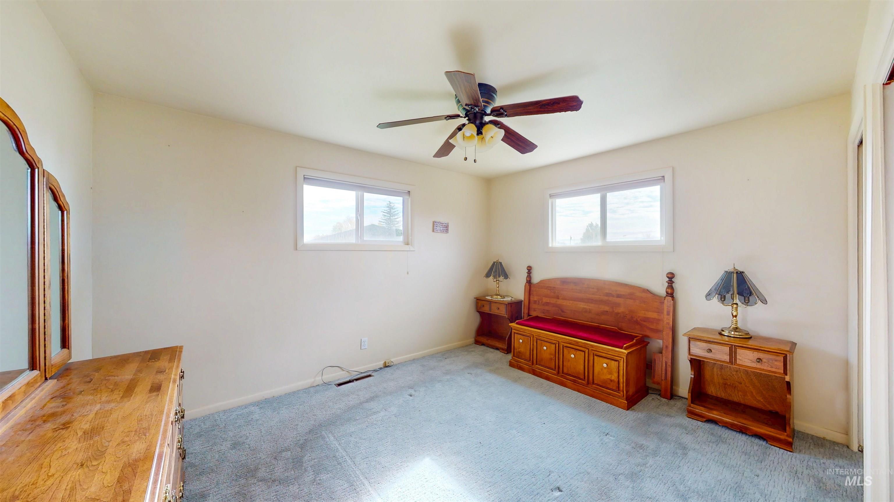 Bedroom with carpet and a ceiling fan