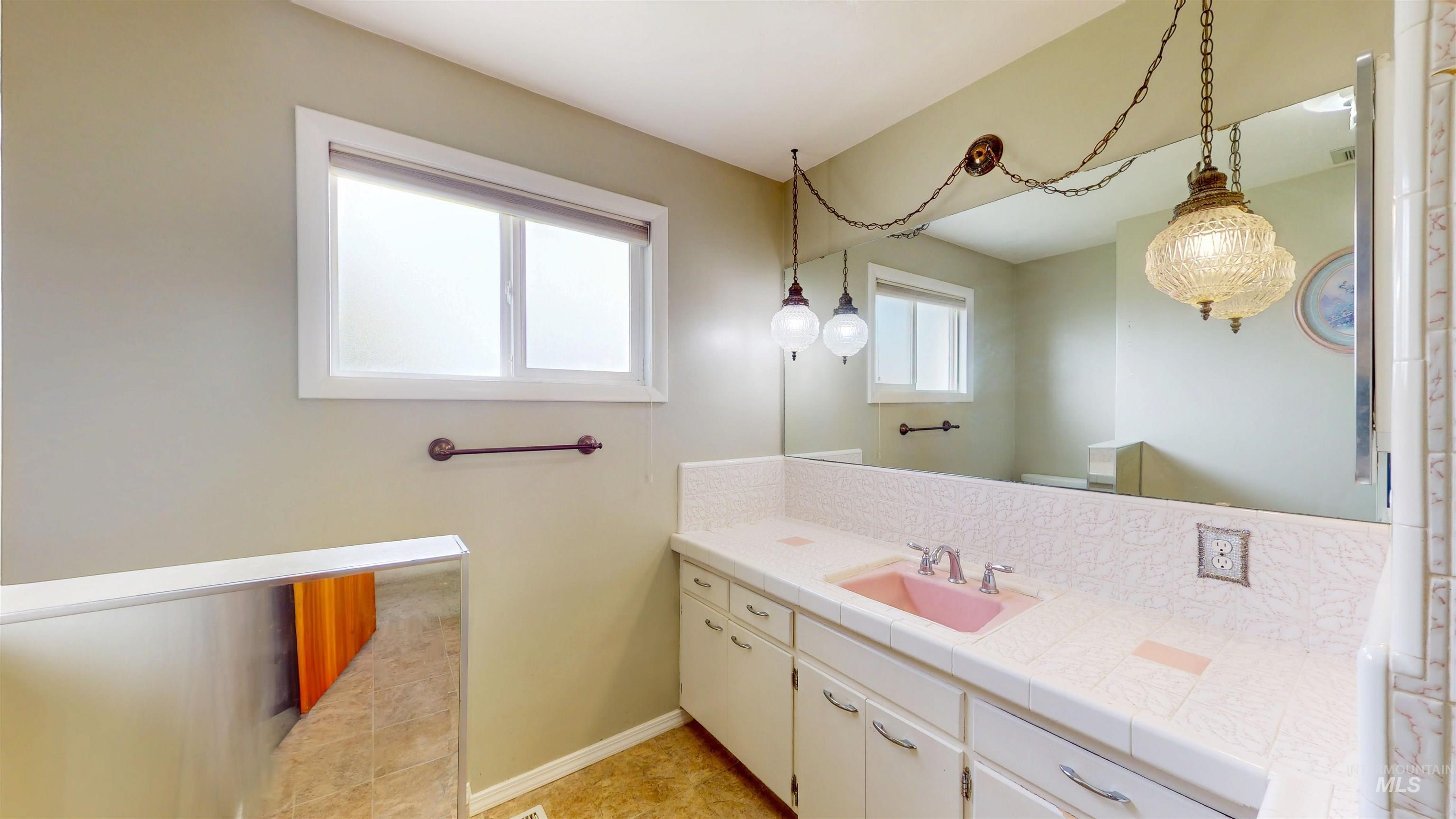 Bathroom featuring vanity and baseboards