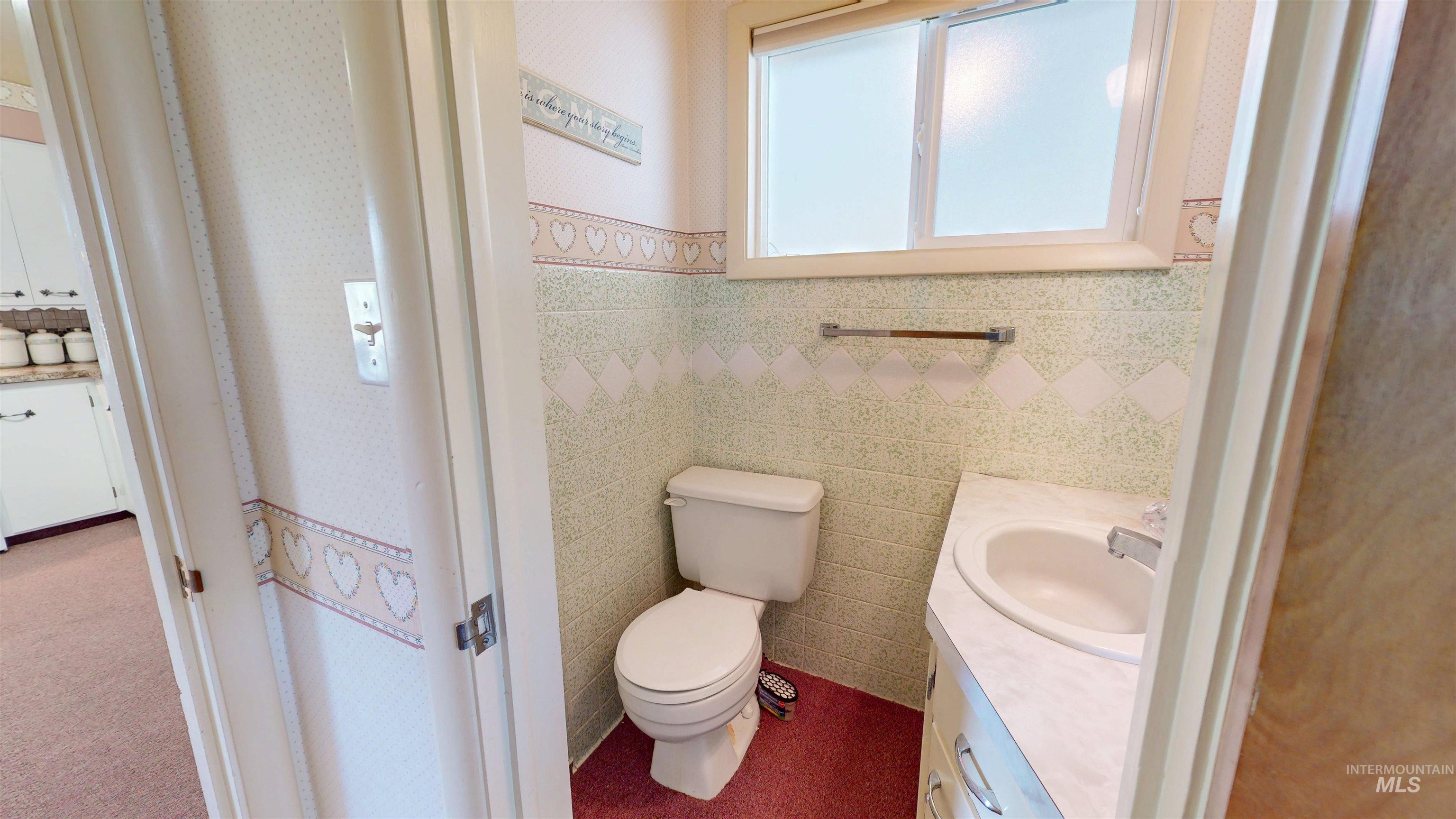 Half bath featuring vanity and toilet