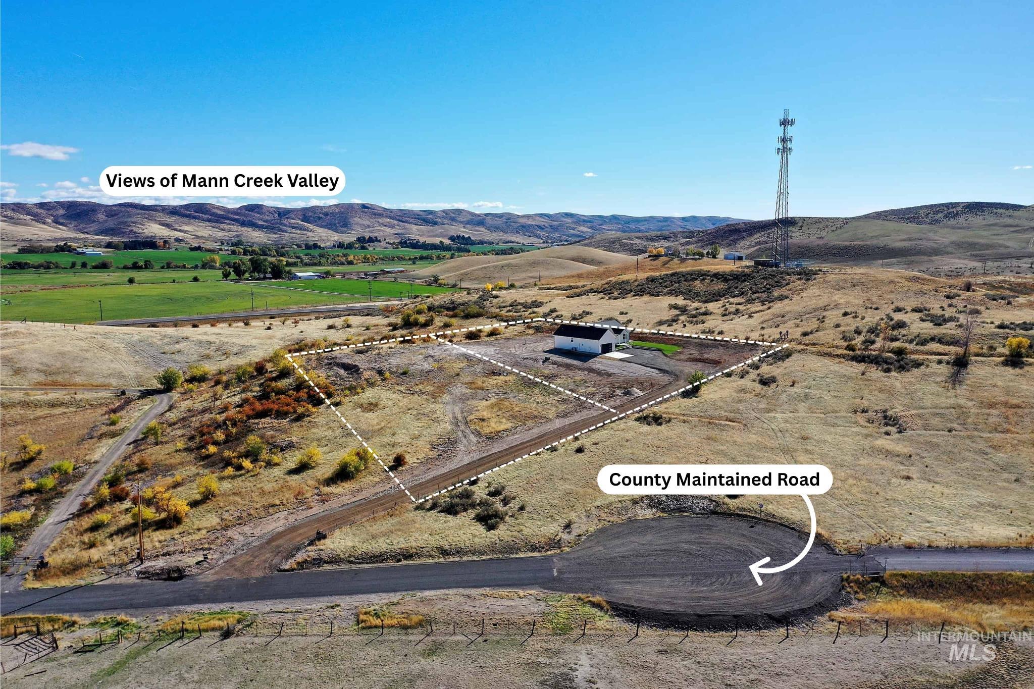 Overview of rural landscape featuring a mountainous background and property parcel outlined