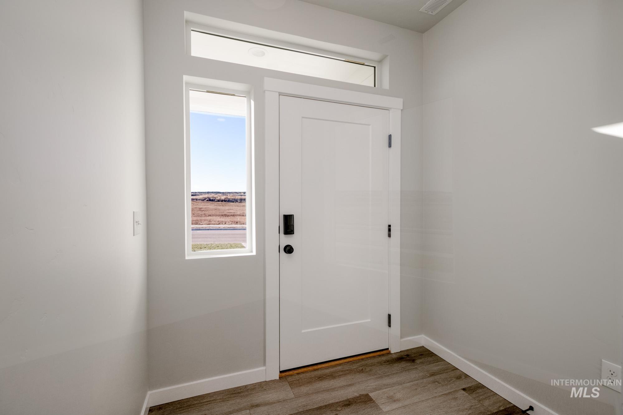 Foyer entrance featuring plenty of natural light and light wood finished floors