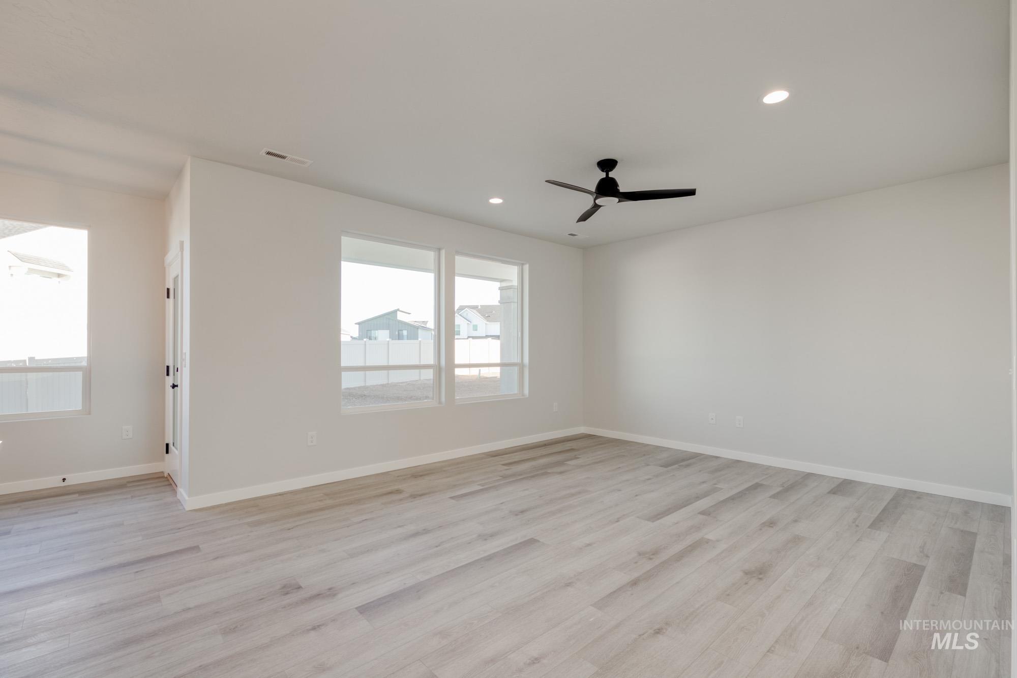 Empty room featuring light wood-type flooring, recessed lighting, and ceiling fan