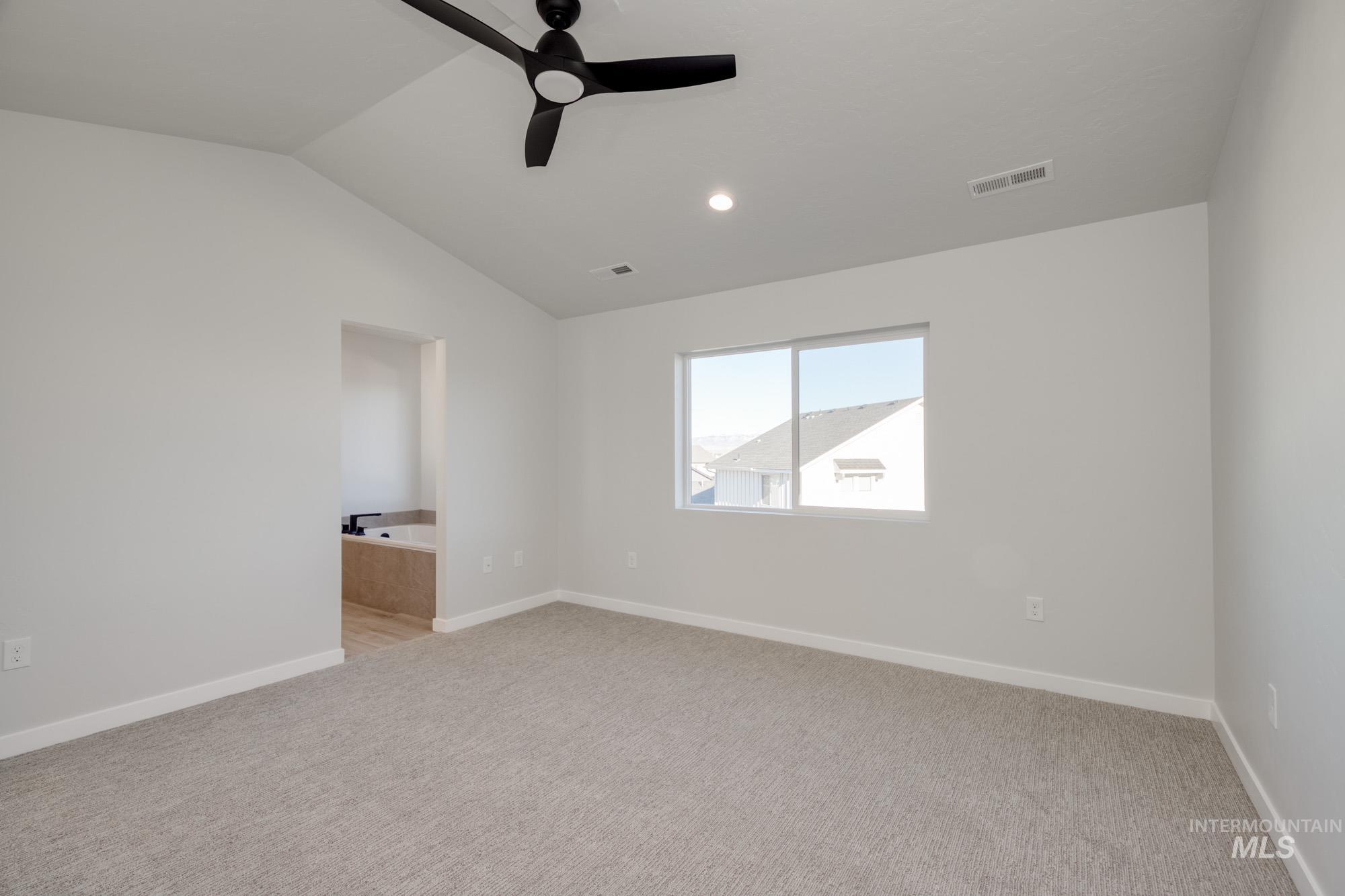 Unfurnished room featuring light colored carpet, ceiling fan, lofted ceiling, and recessed lighting