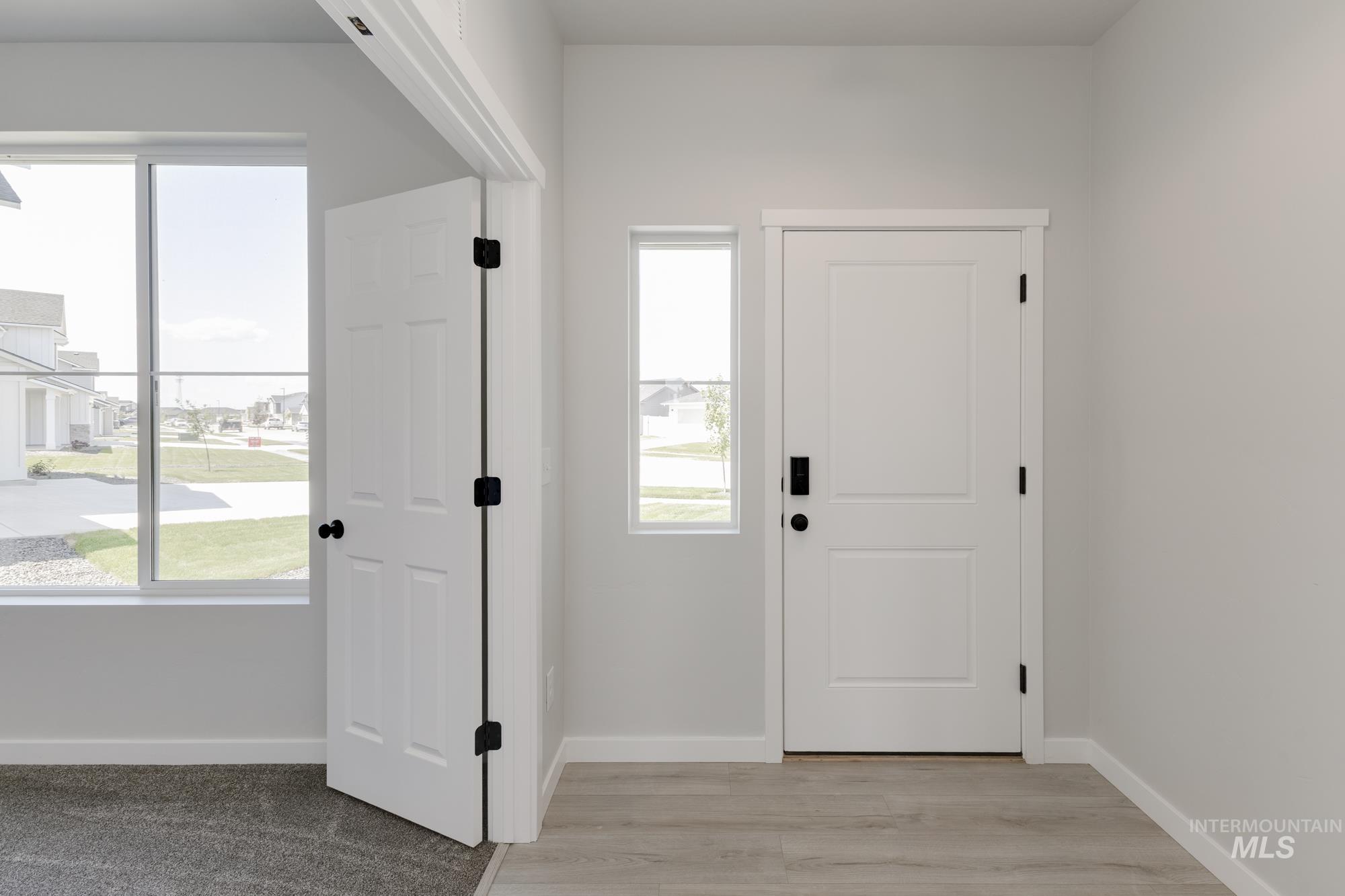 Foyer entrance featuring baseboards and light wood-type flooring