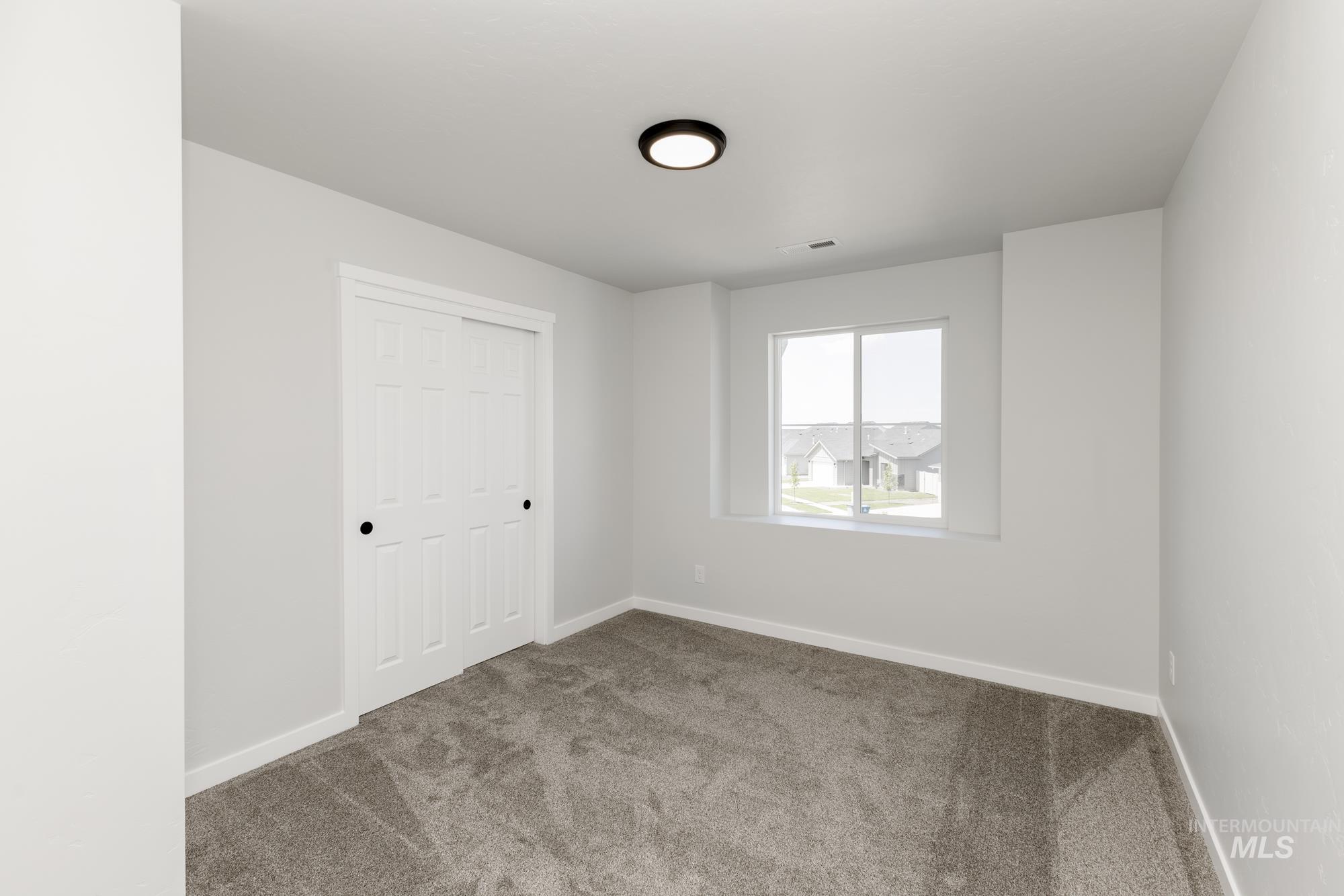 Unfurnished bedroom with carpet and a closet