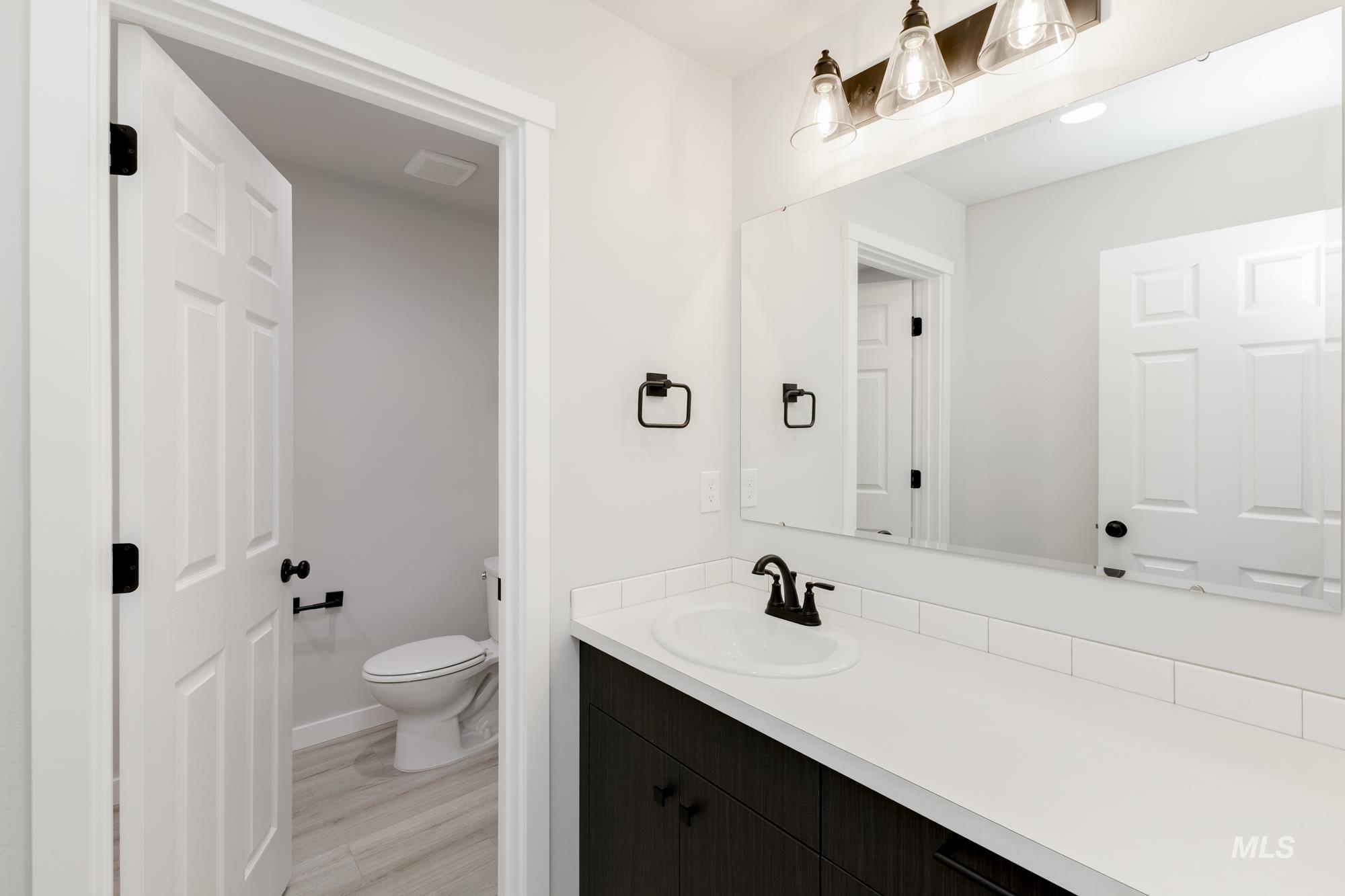 Bathroom with vanity and light wood finished floors