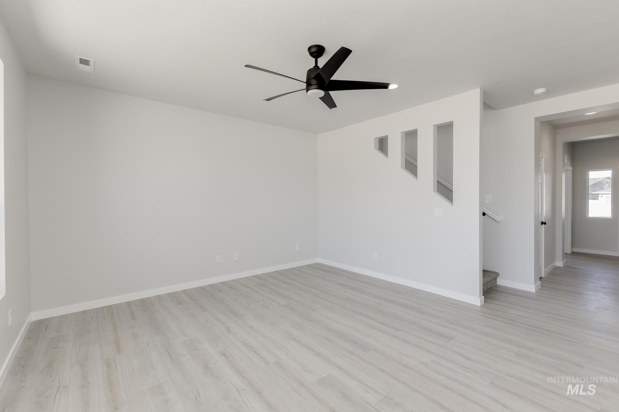 Empty room with light wood finished floors, ceiling fan, and recessed lighting
