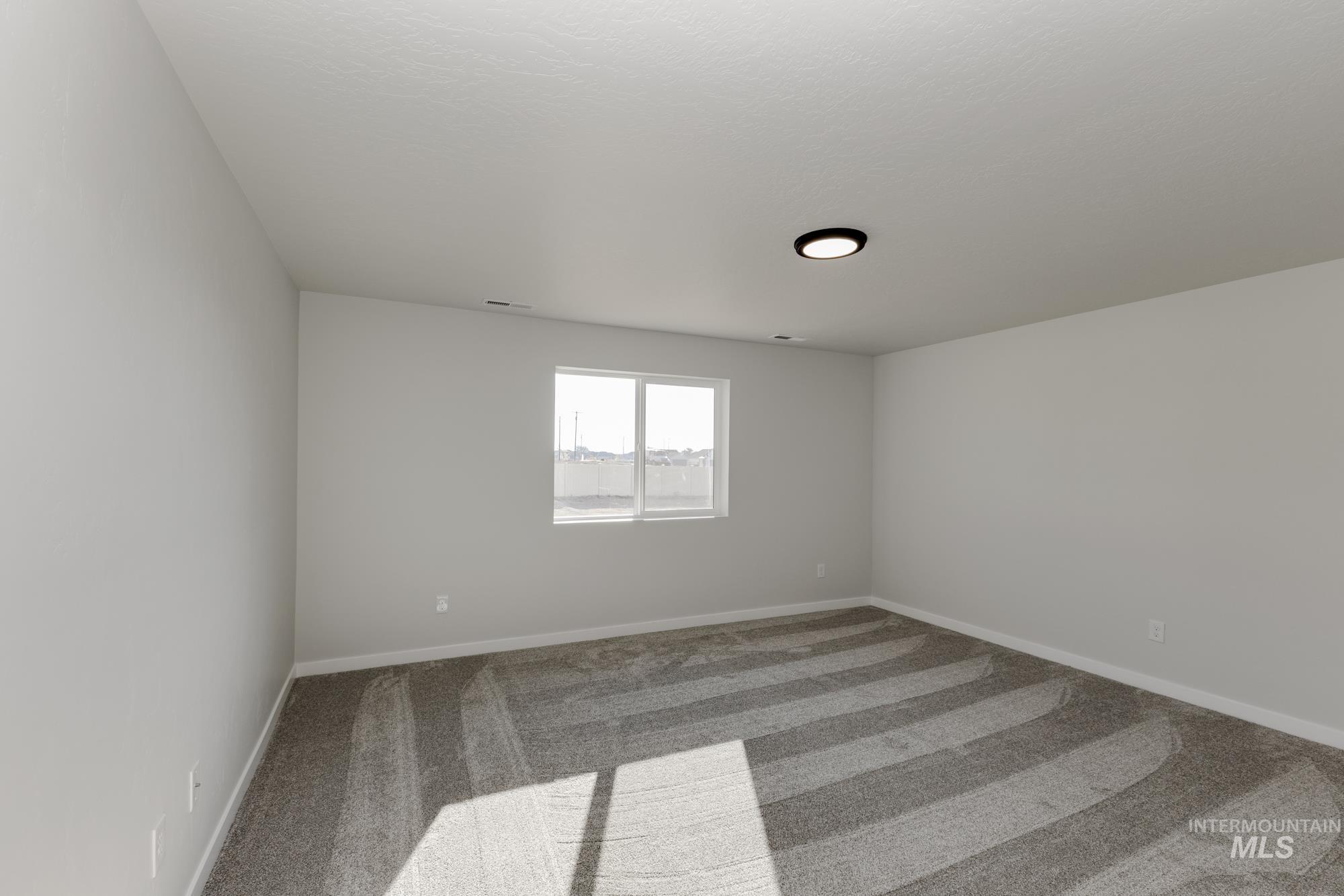 Spare room with carpet flooring and baseboards