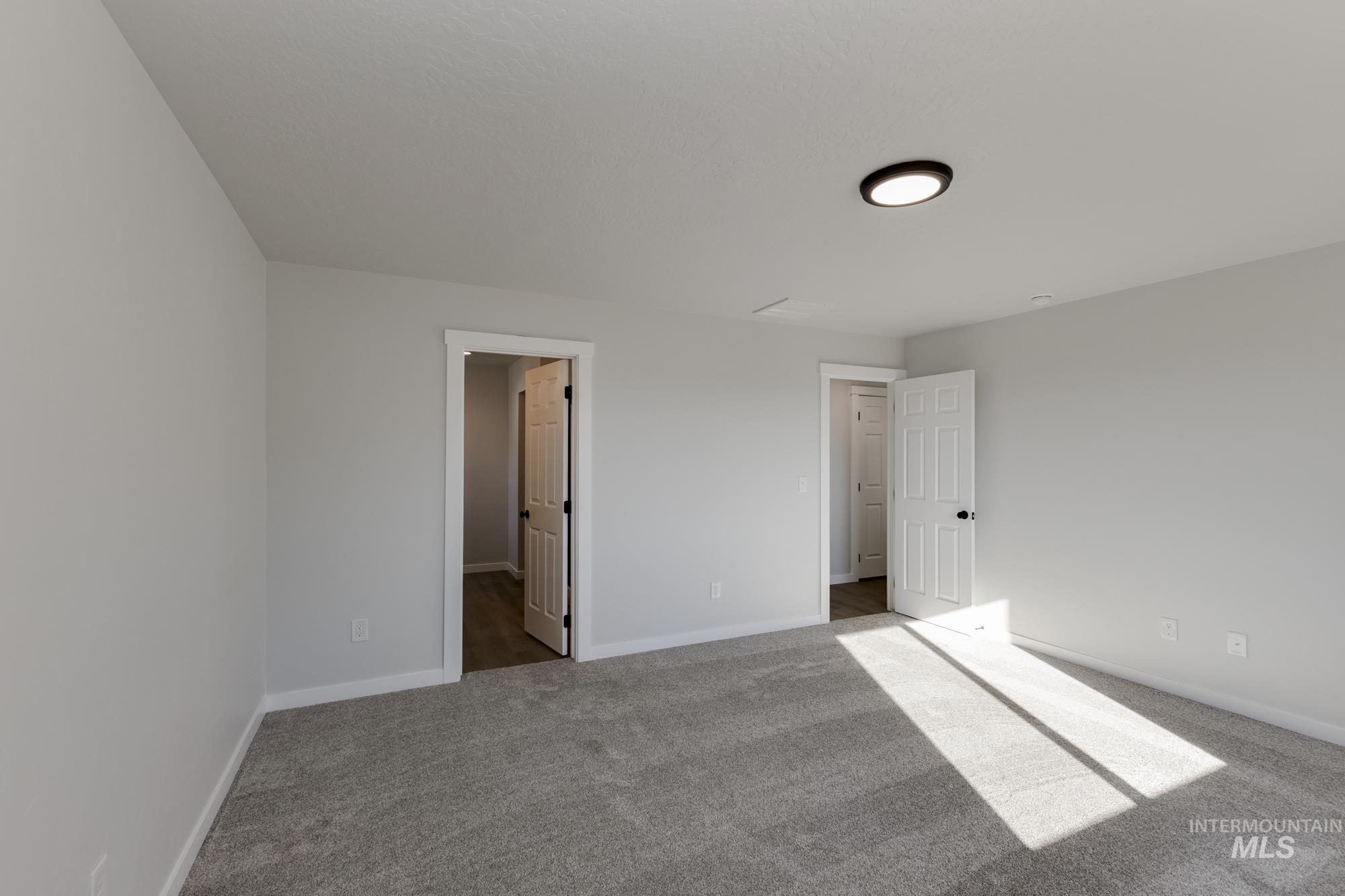 Unfurnished bedroom featuring carpet flooring and baseboards