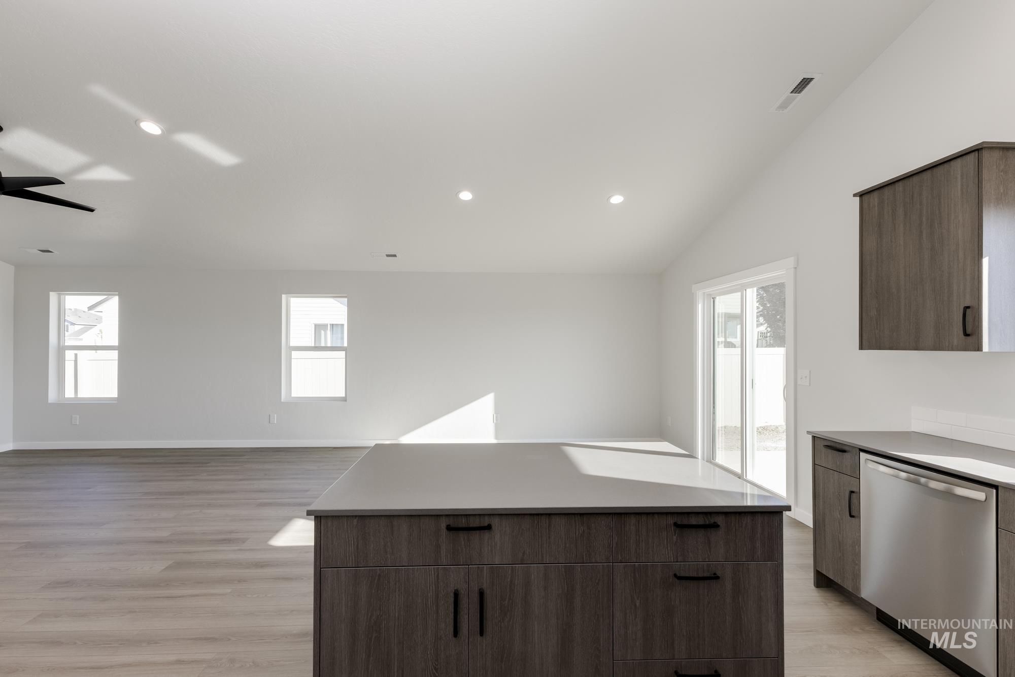 Kitchen with modern cabinets, dishwasher, a center island, light wood-style flooring, and recessed lighting