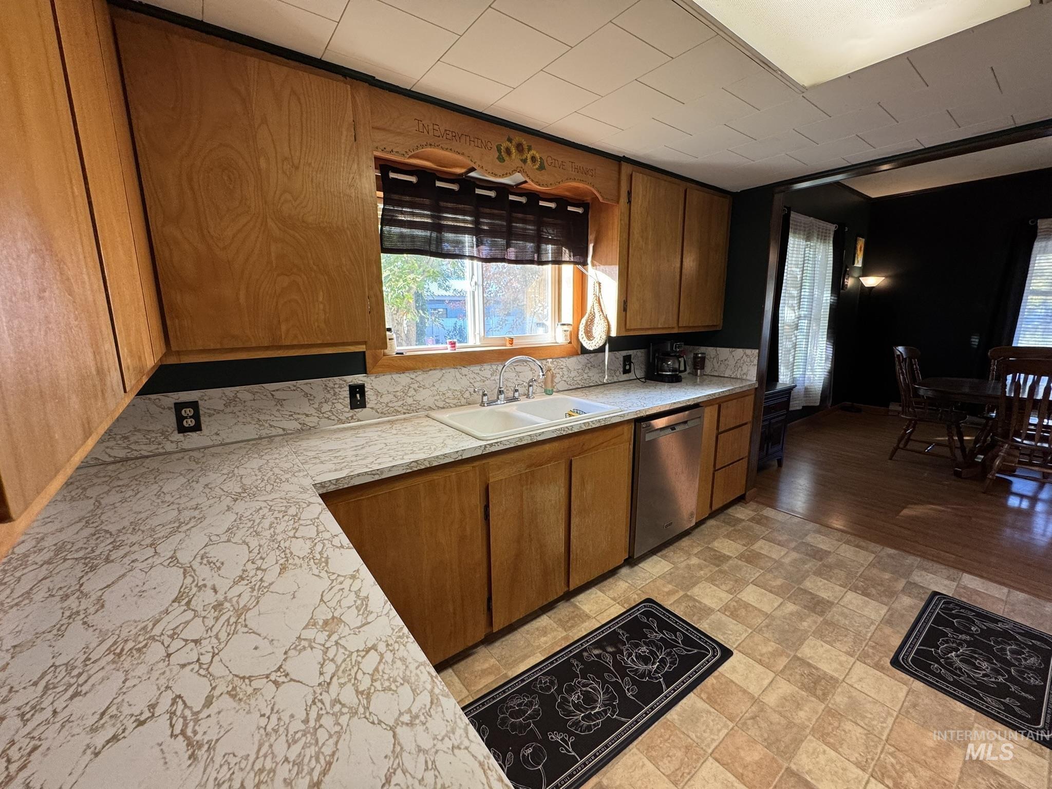 Kitchen featuring brown cabinetry and dishwasher