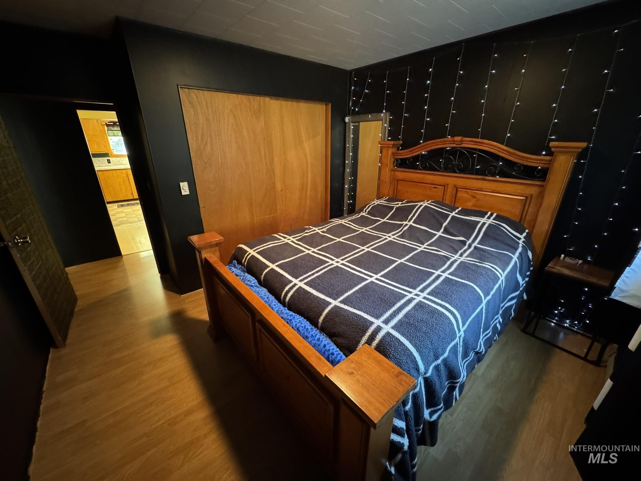 Bedroom with a closet and wood finished floors