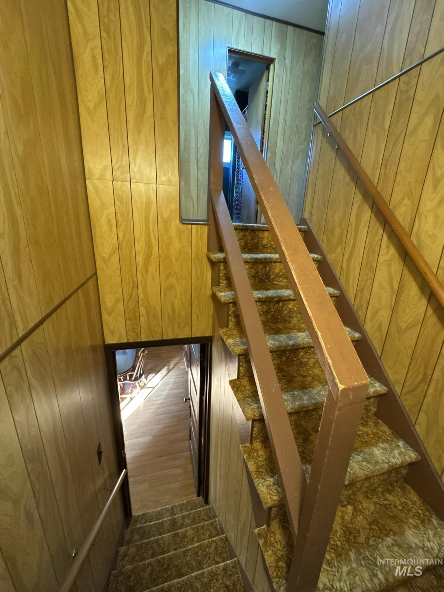 Stairs with wood walls and wood finished floors