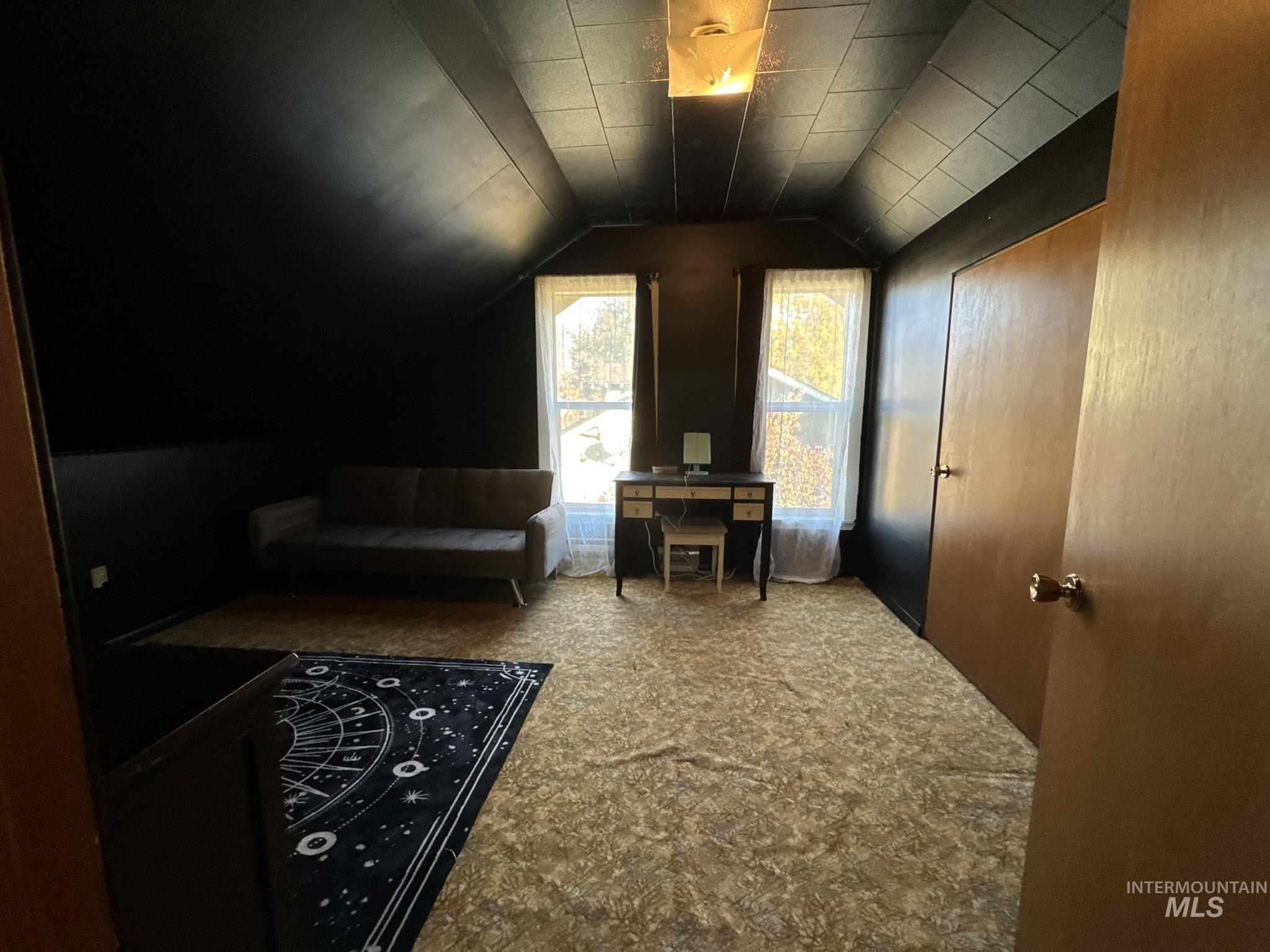 Bonus room with lofted ceiling and carpet