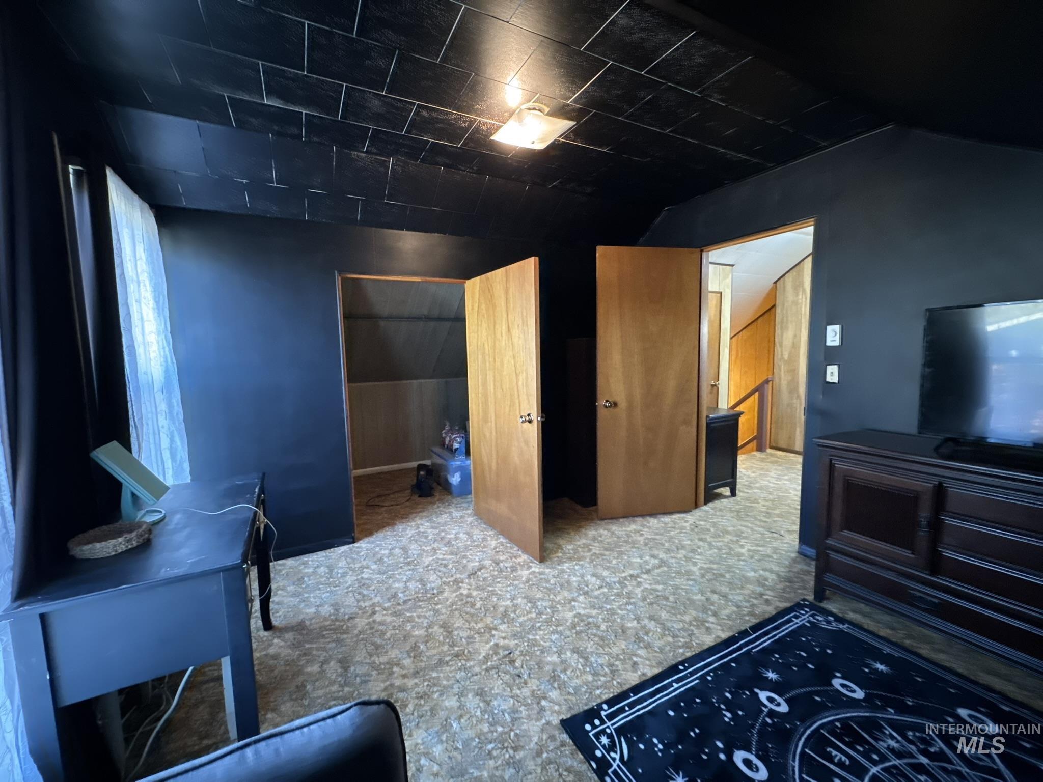 Unfurnished bedroom featuring a closet, lofted ceiling, and carpet floors
