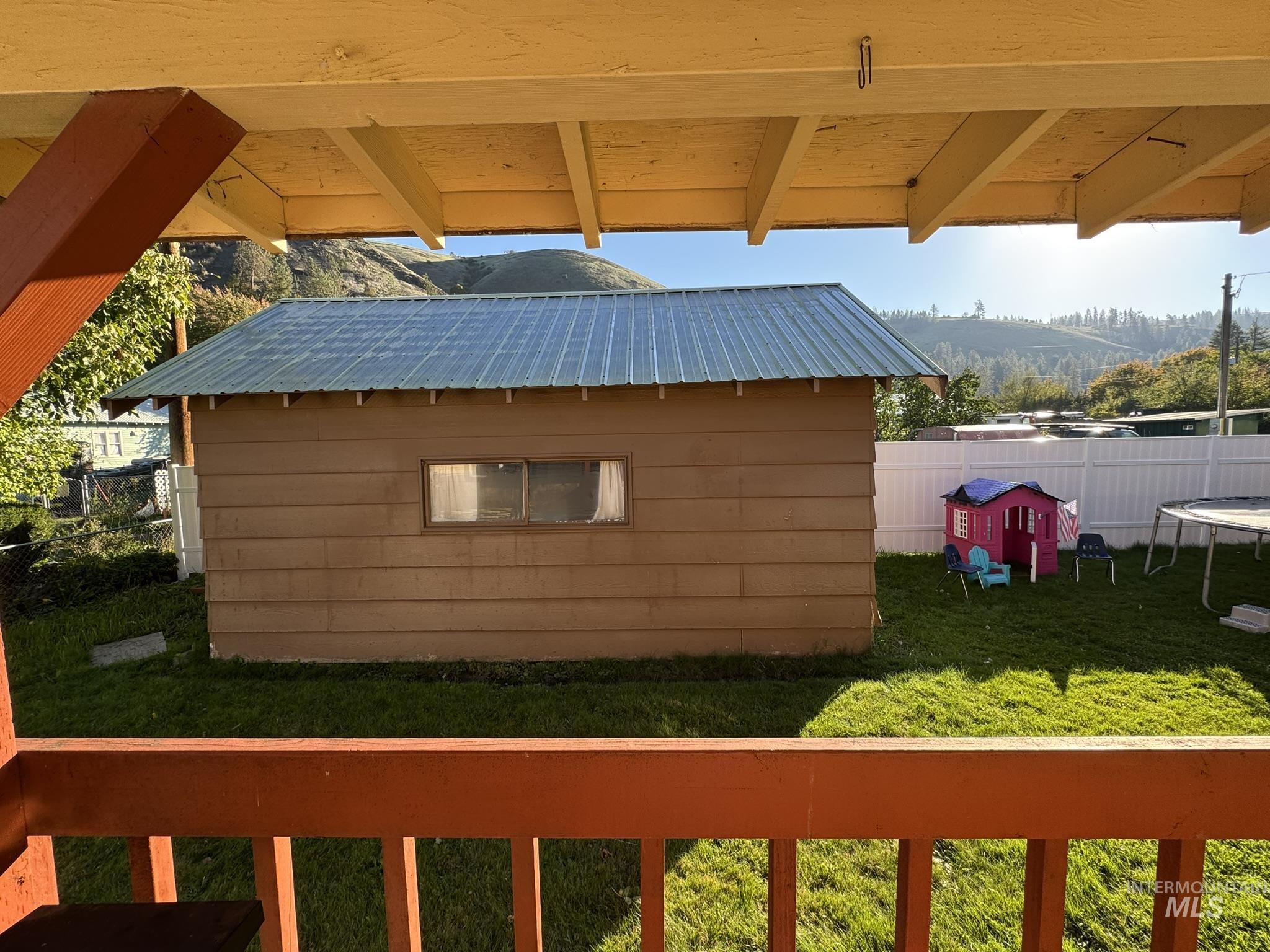 View of outbuilding featuring a trampoline and a mountain view