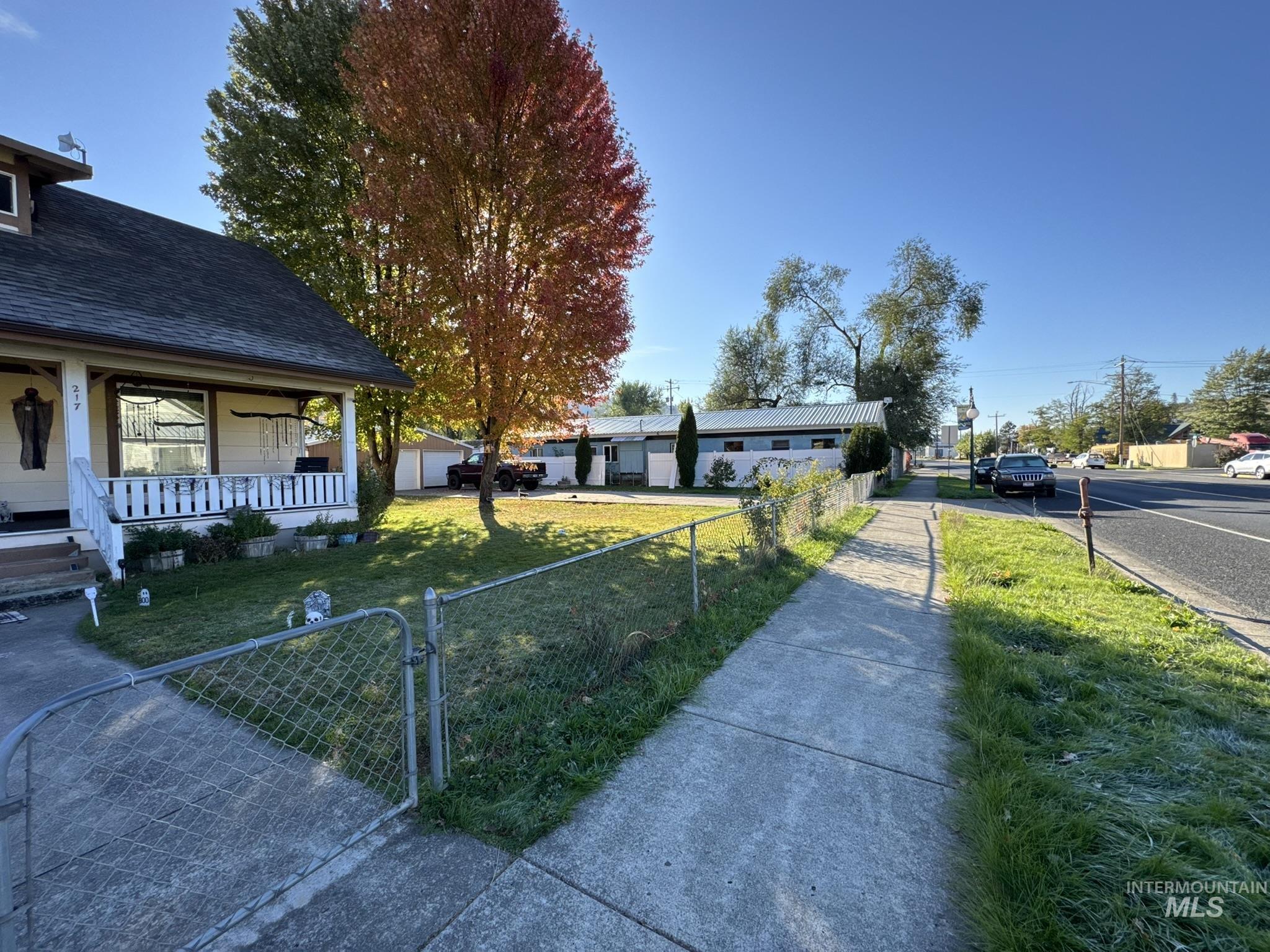 Fenced front yard featuring a gate and covered porch