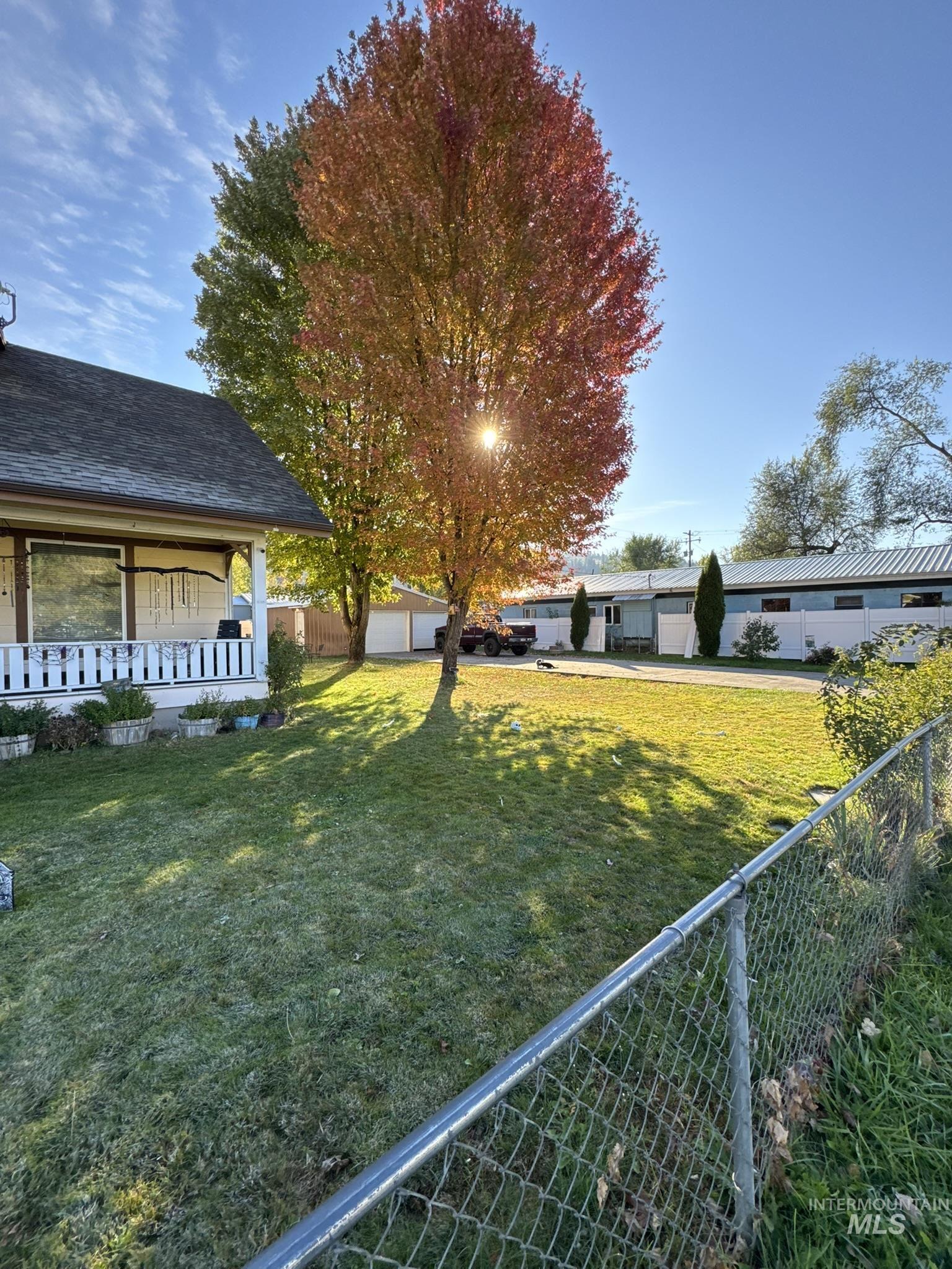 Fenced yard featuring covered porch