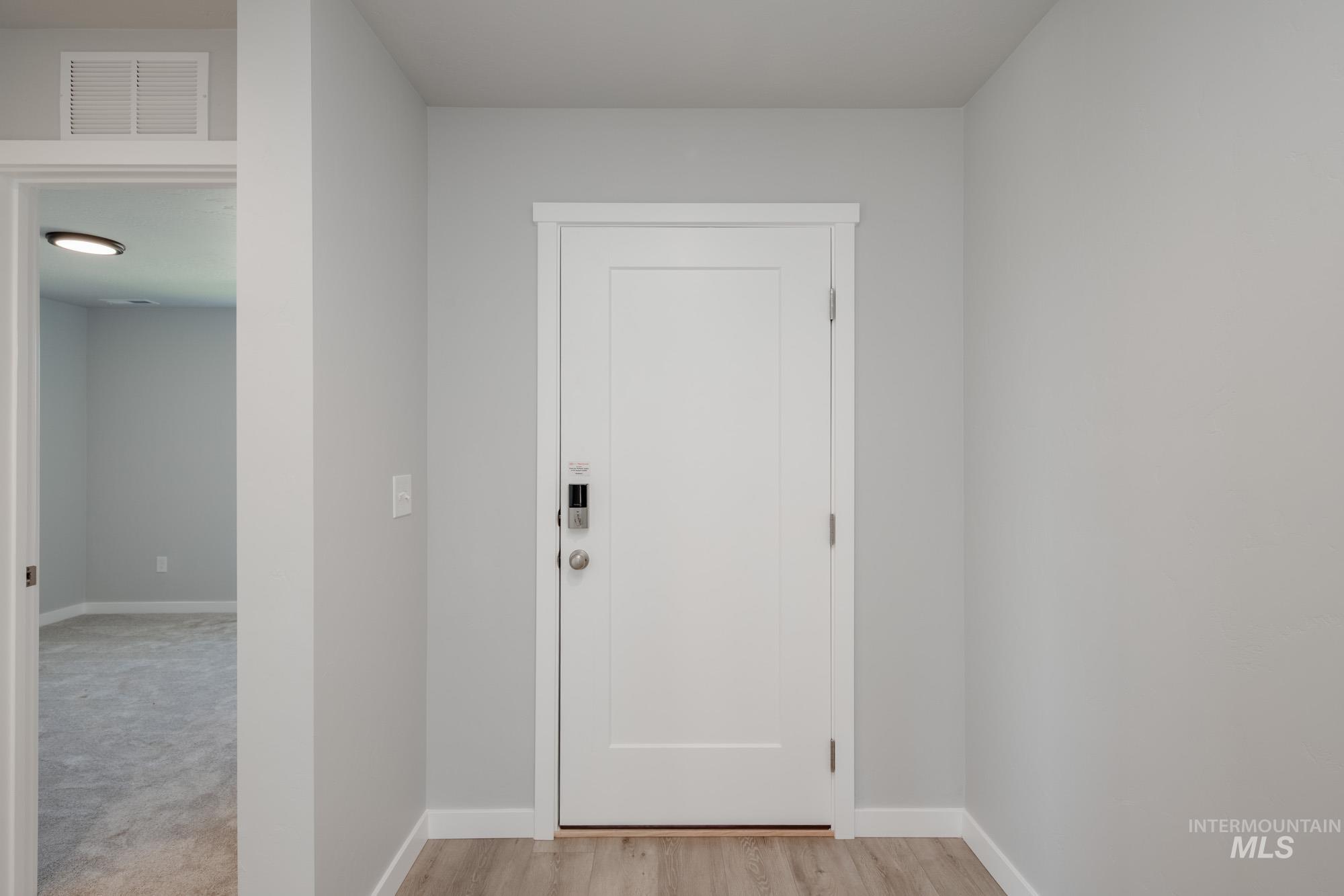 Entryway with baseboards and wood finished floors