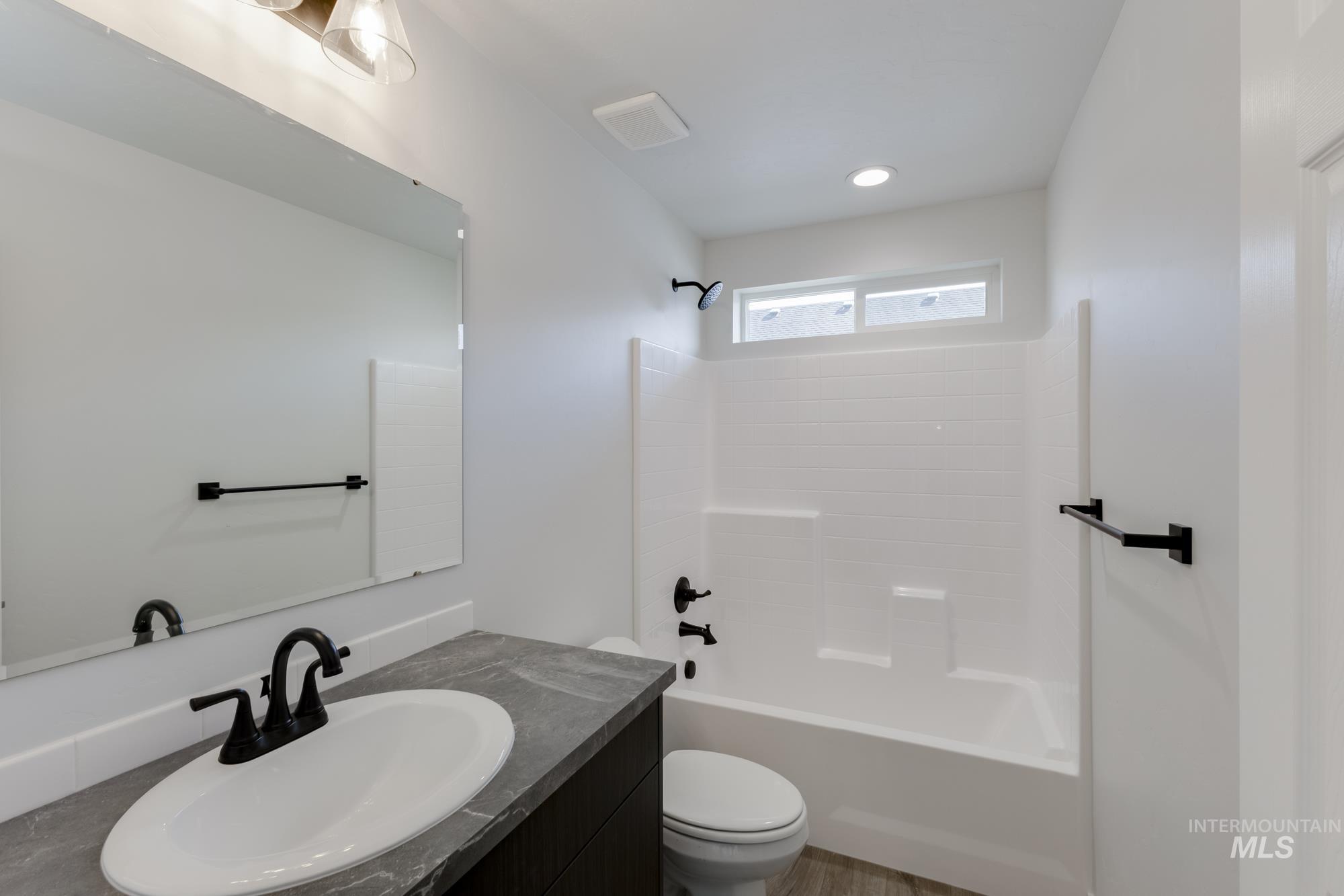 Bathroom featuring bathtub / shower combination and vanity